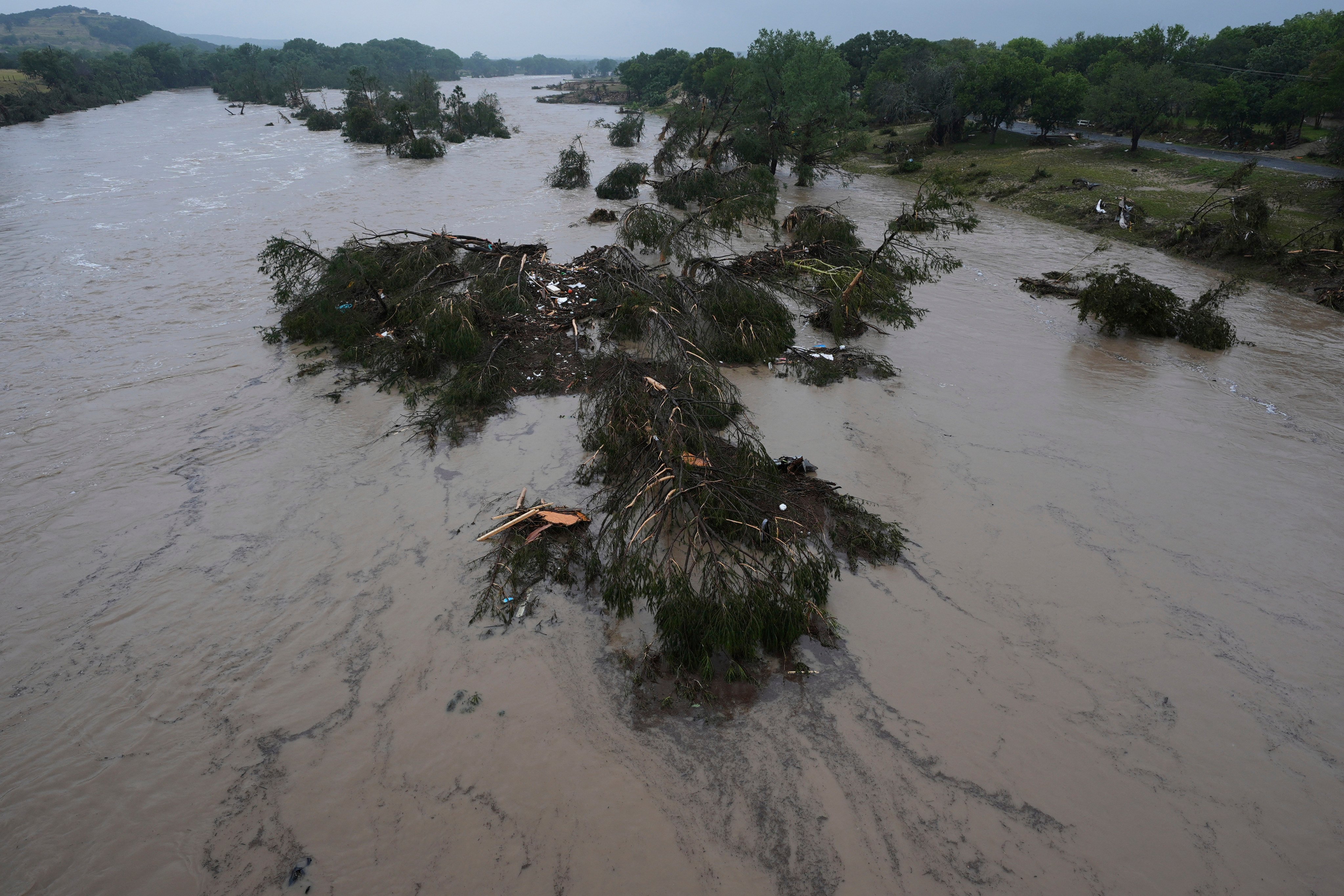 A raging Guadalupe River leaves fallen trees and debris in its wake in Kerrville, Texas, on Friday. Photo: AP