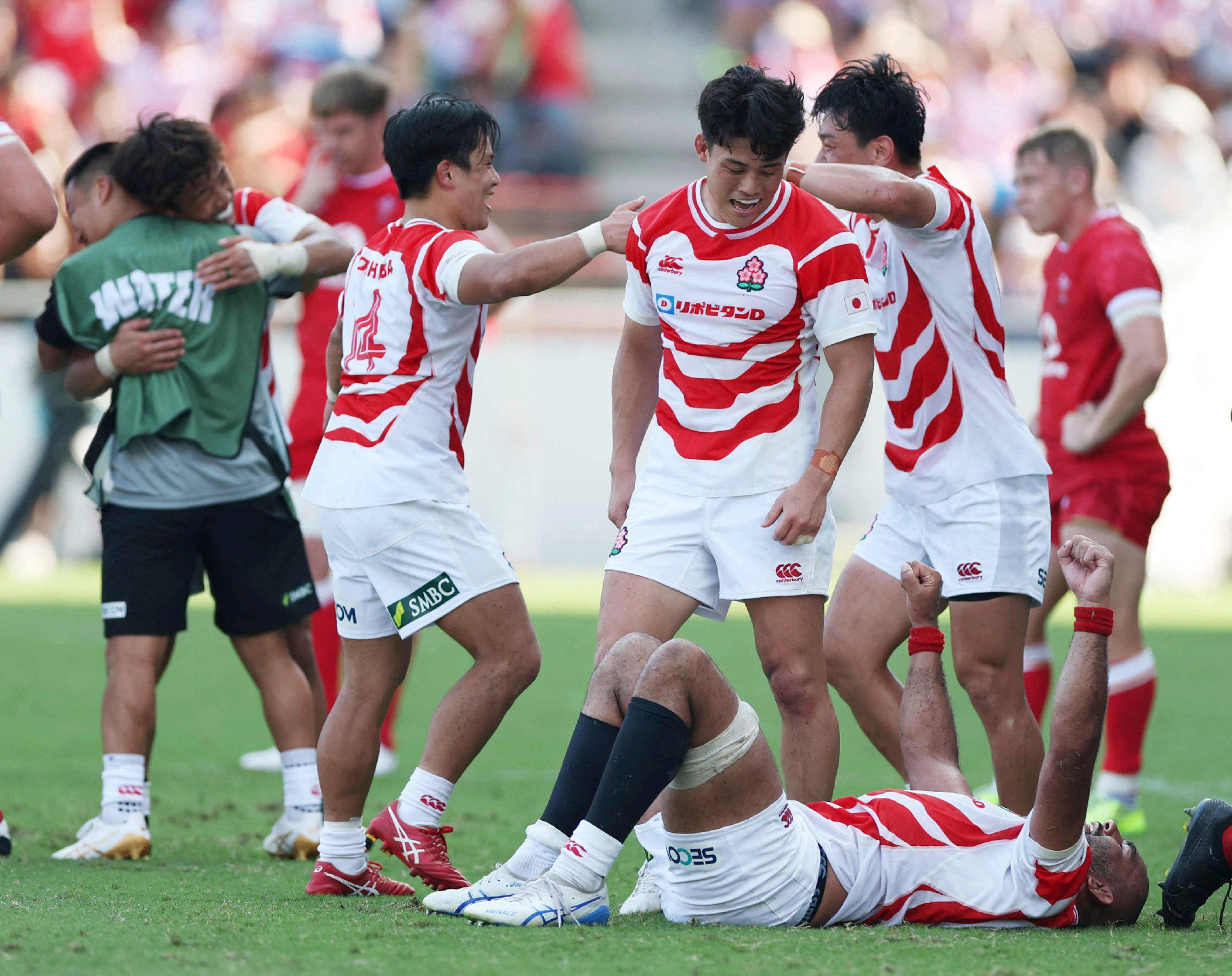 Japan players celebrate their victory in the rugby Test against Wales at the Mikuni World Stadium Kitakyushu in Kitakyushu on Saturday. Photo: AFP