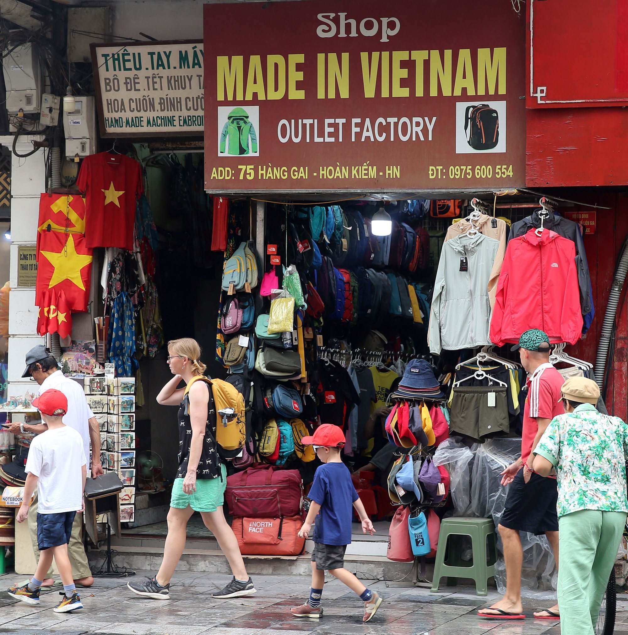 Tourists walk past a Made in Vietnam store at a street in Hanoi on Thursday. Photo: EPA Tourists walk past a Made in Vietnam store at a street in Hanoi on Thursday. Photo: EPA