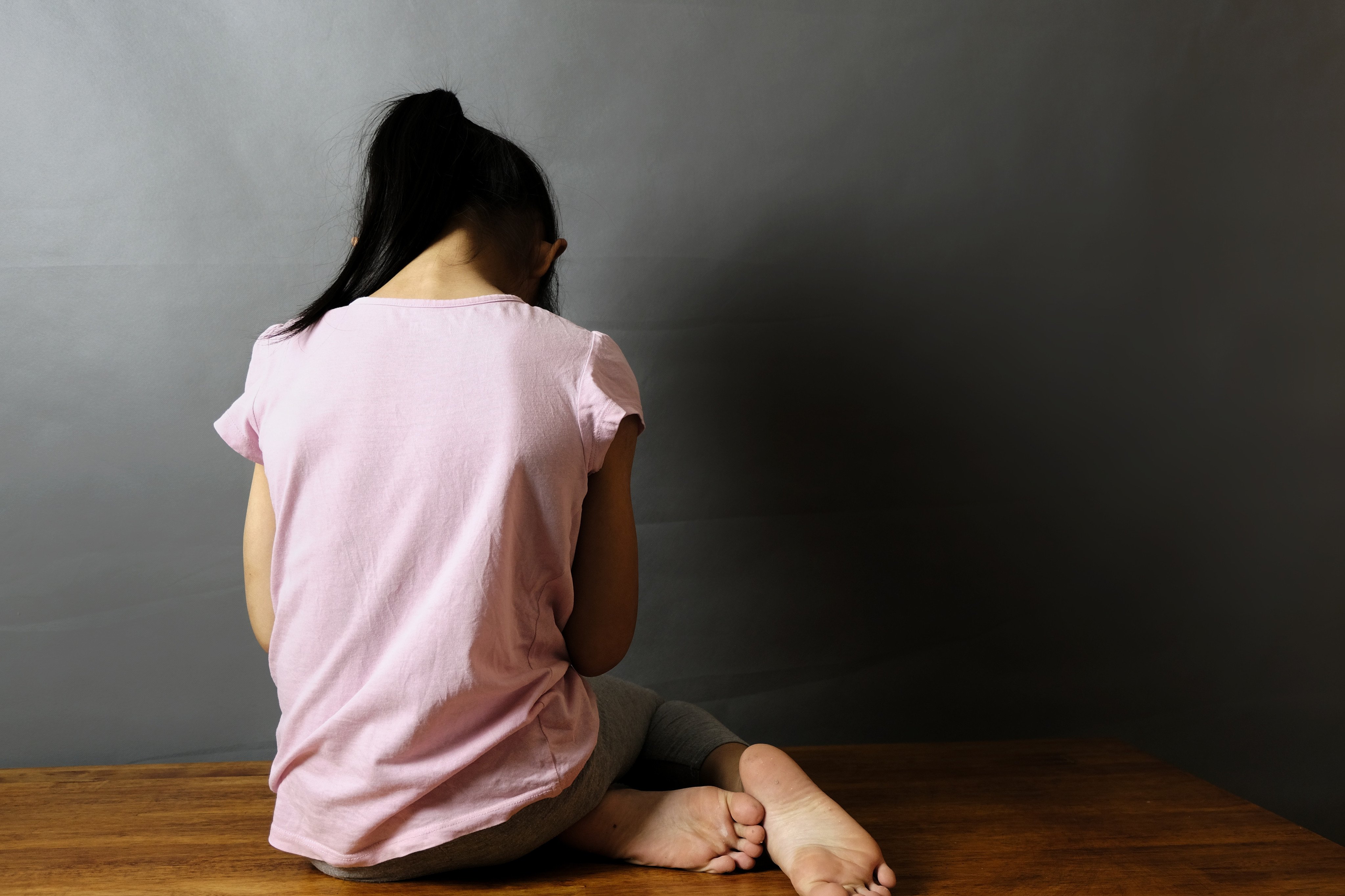 The back view of a girl, crying. A South Korean man has been arrested for child abuse in the Philippines. Photo: Shutterstock