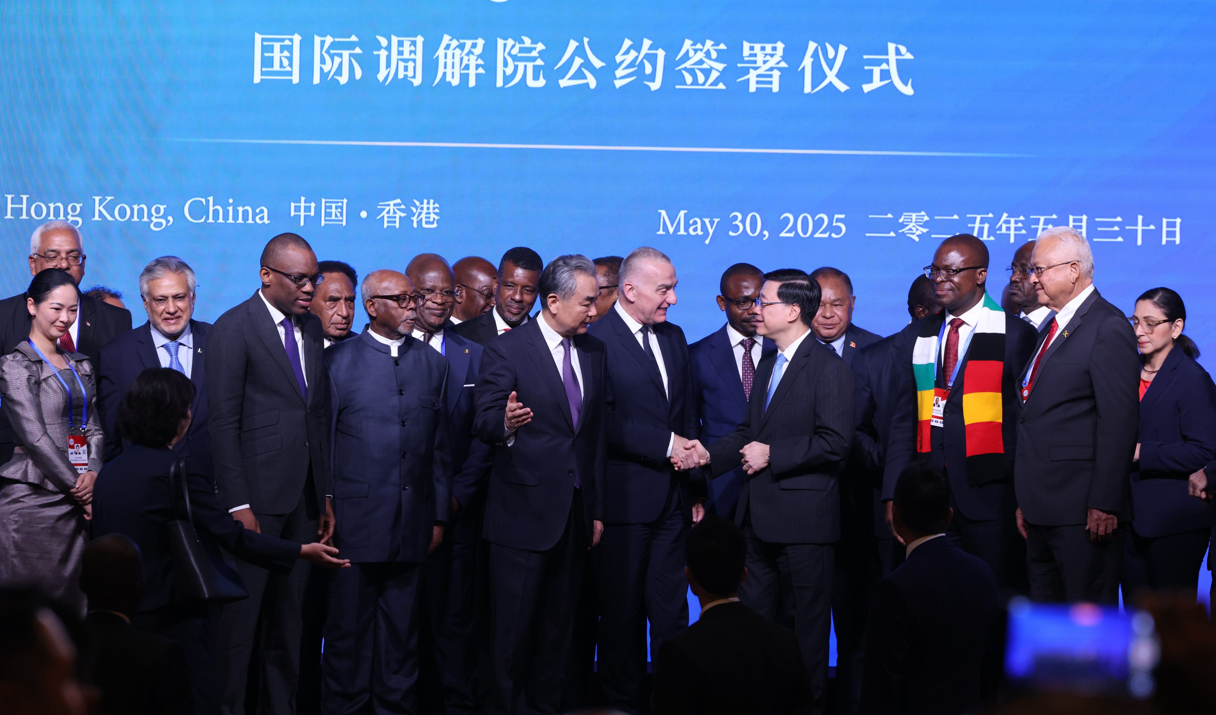 Chinese Foreign Minister Wang Yi (centre left) and Hong Kong Chief Executive John Lee (centre right) attend the signing ceremony for the convention on the establishment of the International Organisation for Mediation in Hong Kong on May 30. Photo: Nora Tam