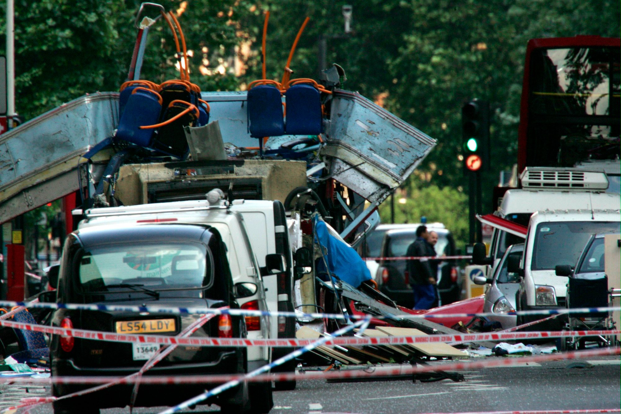 The wreckage of a double-decker bus with its top blown off by a bomb and damaged cars scattered on the road at Tavistock Square in central London on July 7, 2005. Photo: AP