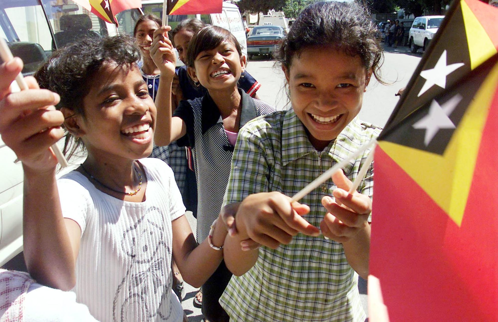 East Timorese children wave their new country’s flags as they celebrate in the streets of Dili on May 19, 2002, the day before it officially became an independent nation. Photo: Reuters