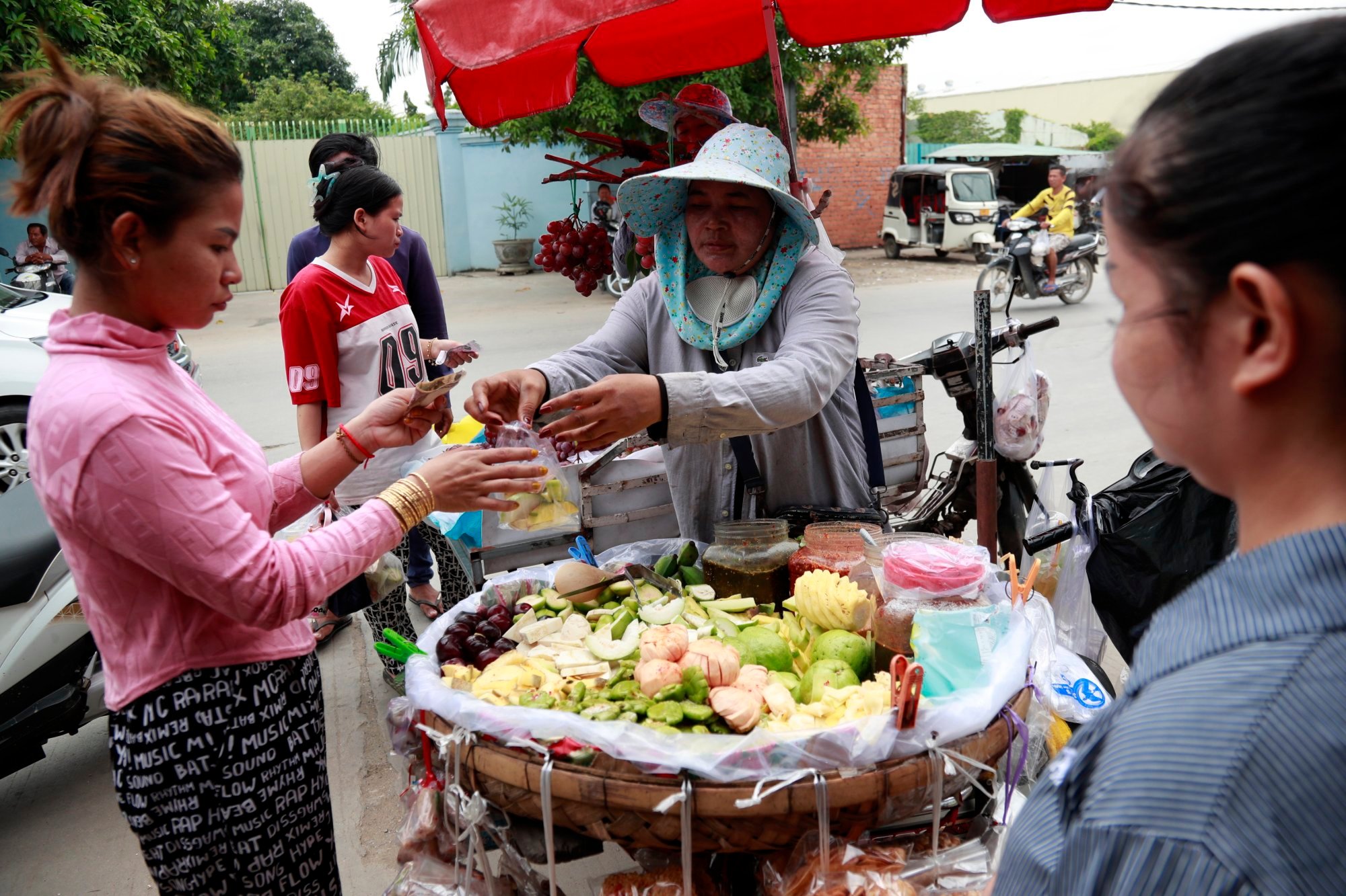 Cambodian workers buy fruit on a street in Phnom Penh, Cambodia, on Tuesday. Trump has announced a 36 per cent tariff on Cambodia. Photo: EPA Cambodian workers buy fruit on a street in Phnom Penh, Cambodia, on Tuesday. Trump has announced a 36 per cent tariff on Cambodia. Photo: EPA