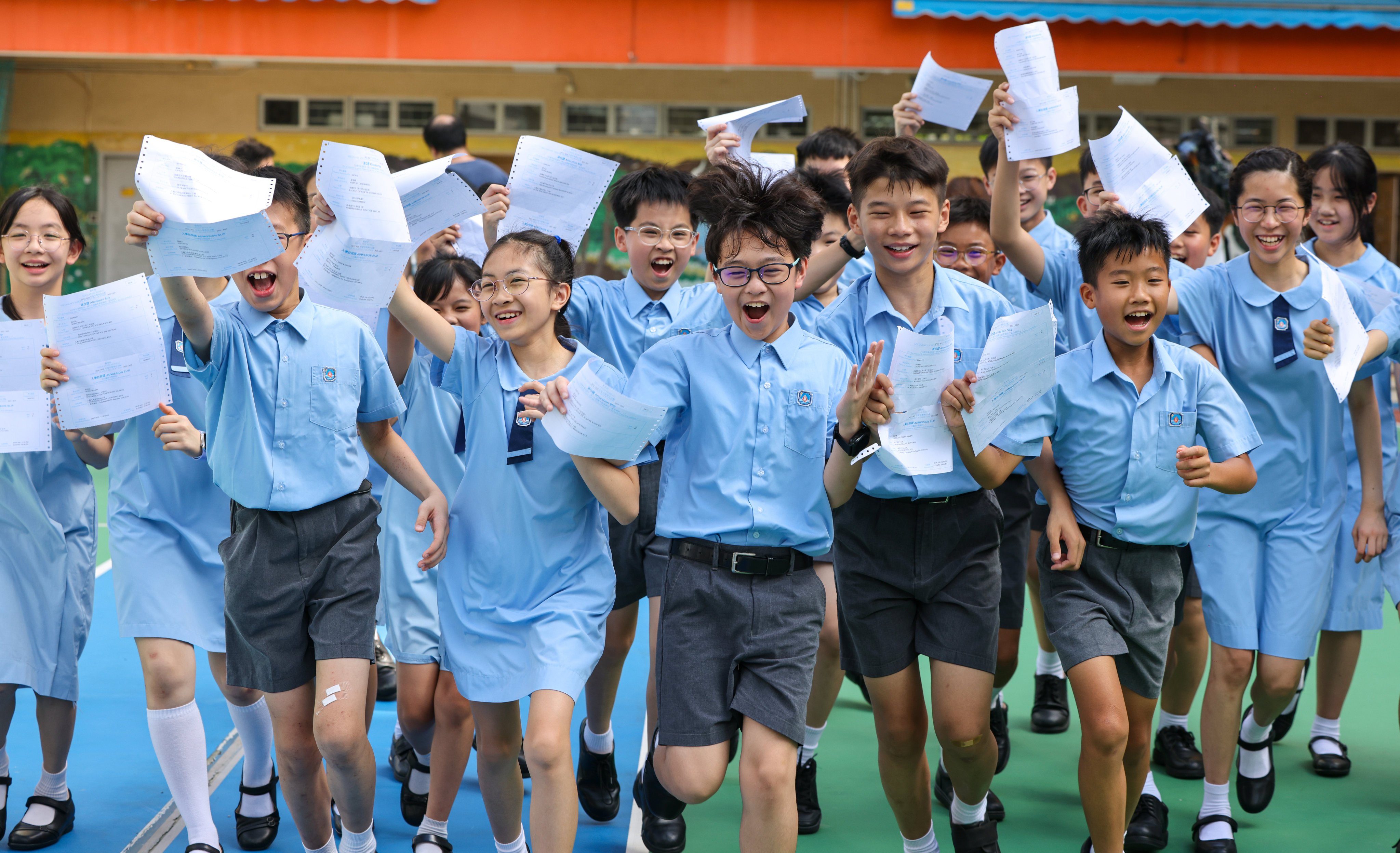 Primary Six students at Yaumati Catholic Primary School (Hoi Wang Road) celebrate their results at their campus in Yau Ma Tei. Photo: Nora Tam