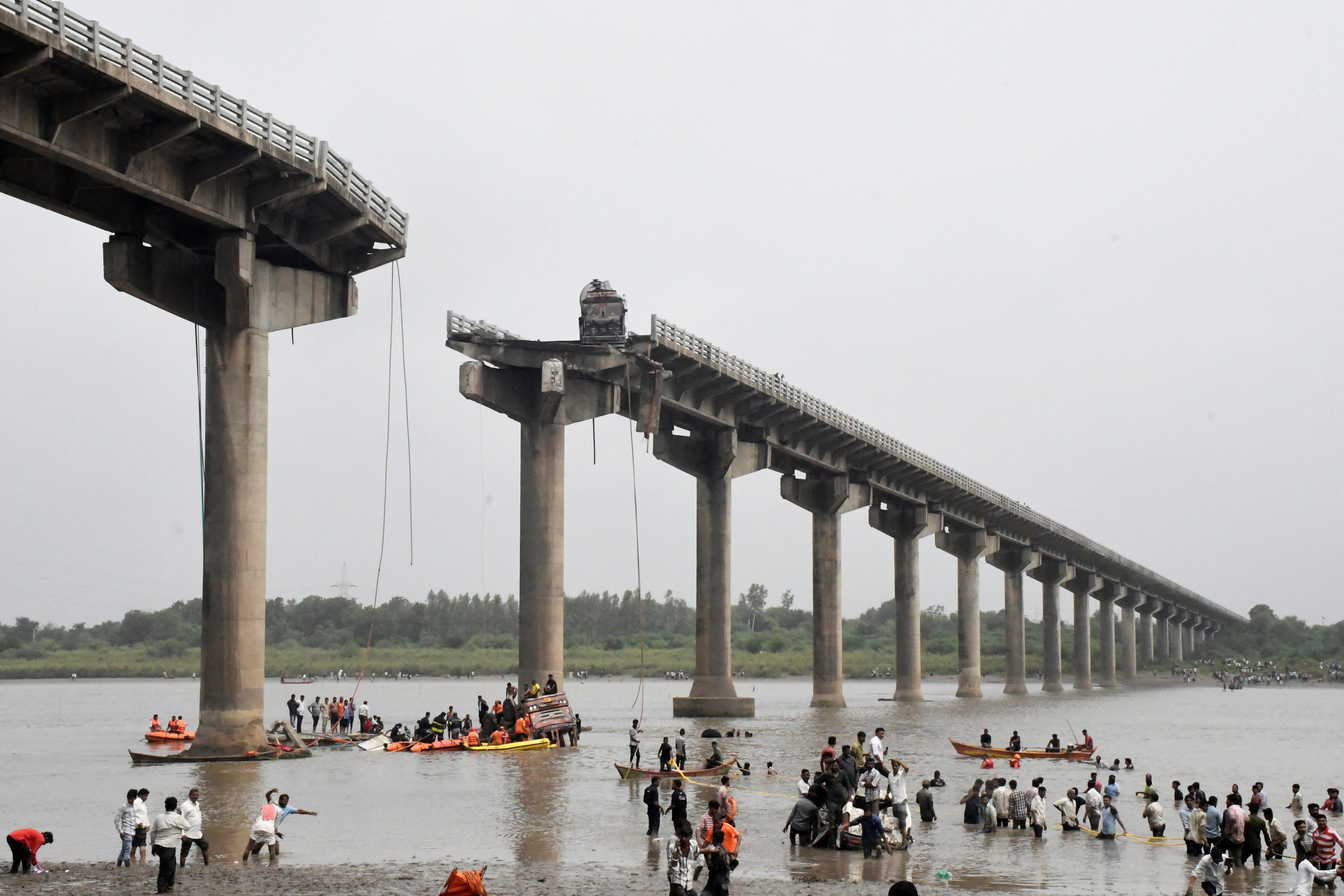 Rescuers search for survivors after a bridge collapsed in Vadodara in the western state of Gujarat on Wednesday. Photo: Reuters