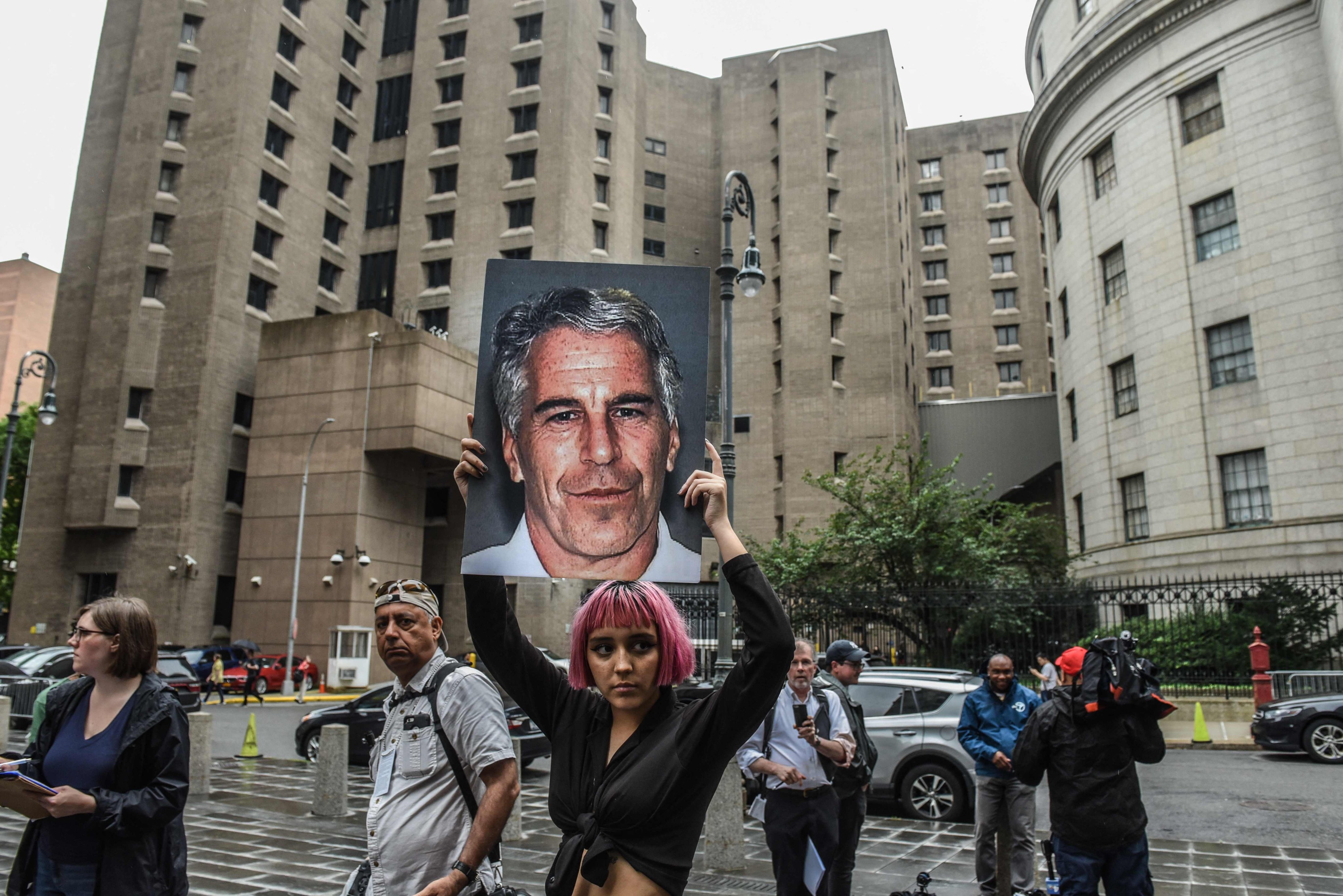 A protester holds up a large picture of Jeffrey Epstein in front of the Metropolitan Correction Centre in New York in 2019. File photo: AFP