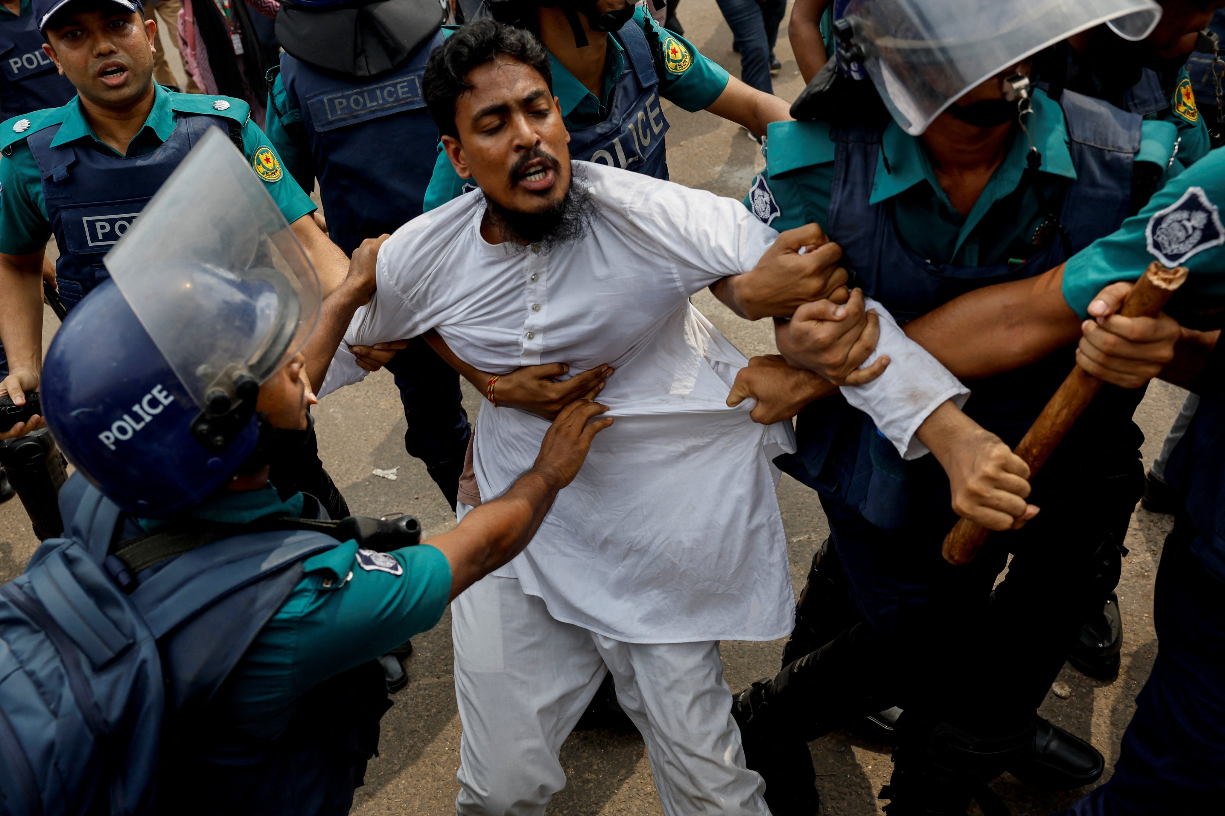 Police detain a man taking part in protesters, in Dhaka, Bangladesh, in July  2024. Photo: Reuters