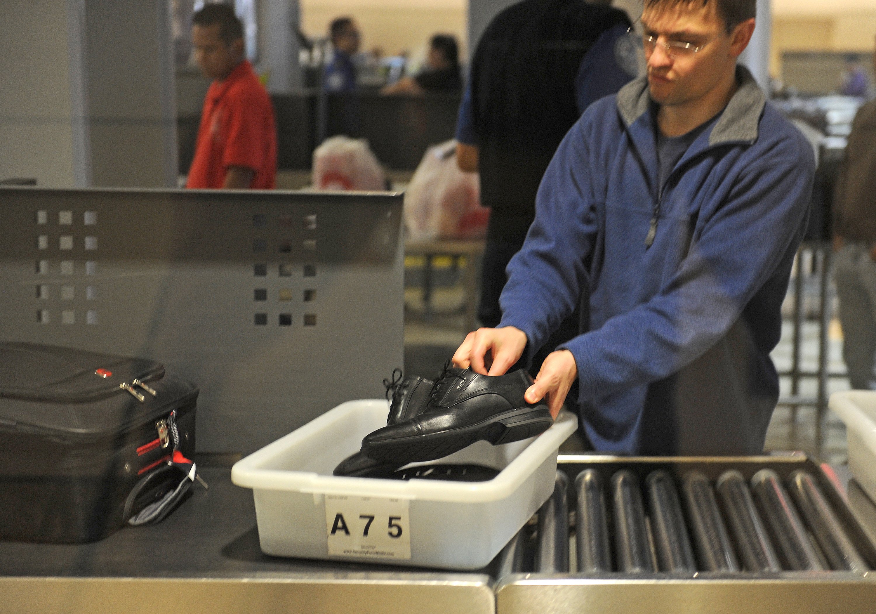 A traveller places his shoes in a bin before passing through the TSA security check at Los Angeles International Airport. File photo: TNS