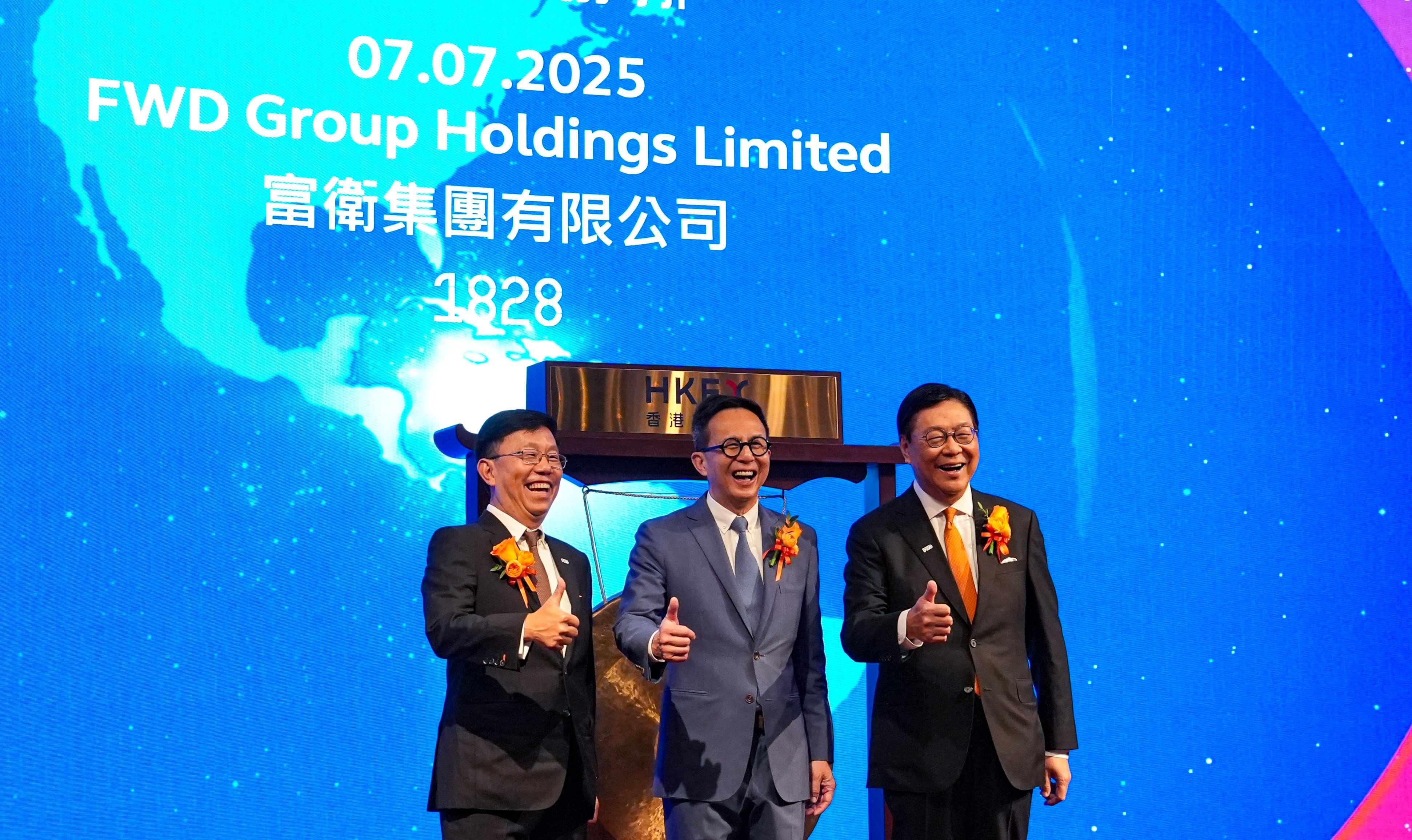From the left, FWD Group’s CEO Huynh Thanh Phong, founder Richard Li and chairman Frederick Ma Si-hang celebrate the pan-Asian insurer’s trading debut on the Hong Kong stock exchange on July 7. Photo: Sun Yeung