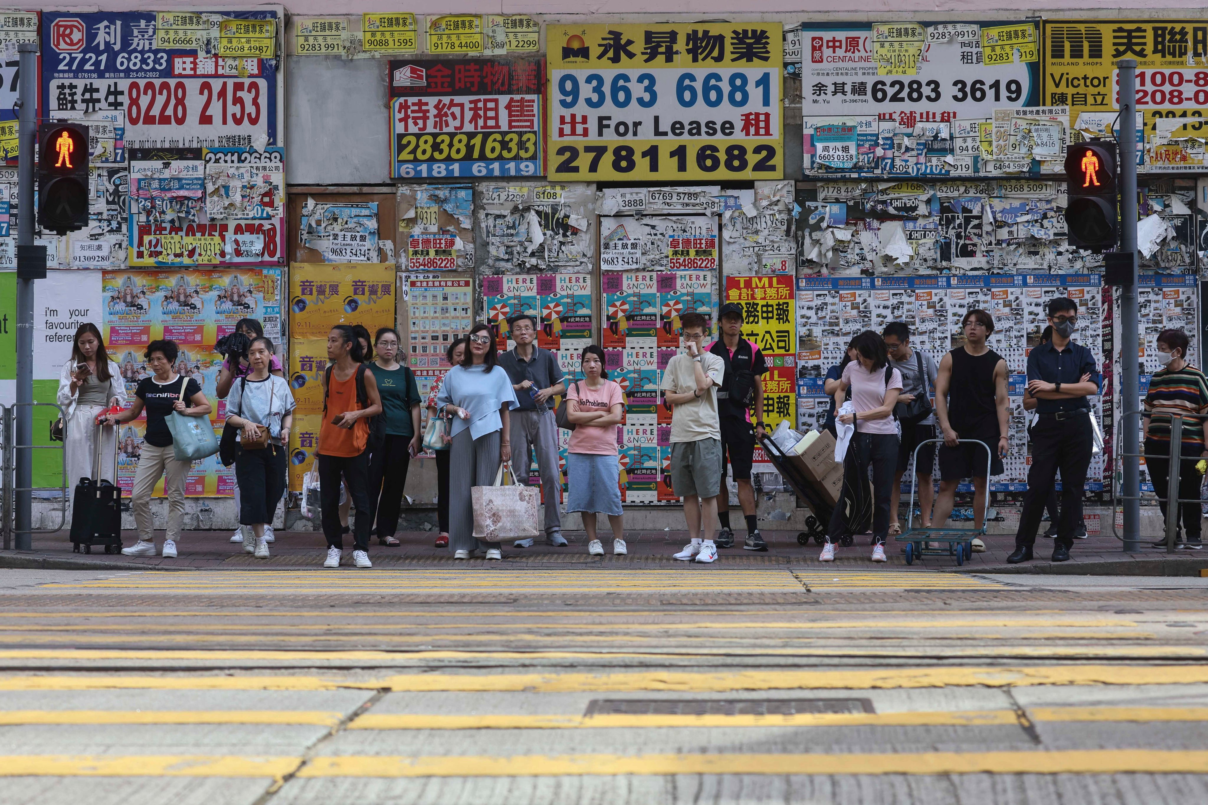 Pedestrians stand in front of closed retail shops in Causeway Bay on August 9, 2024. Photo: Edmond So