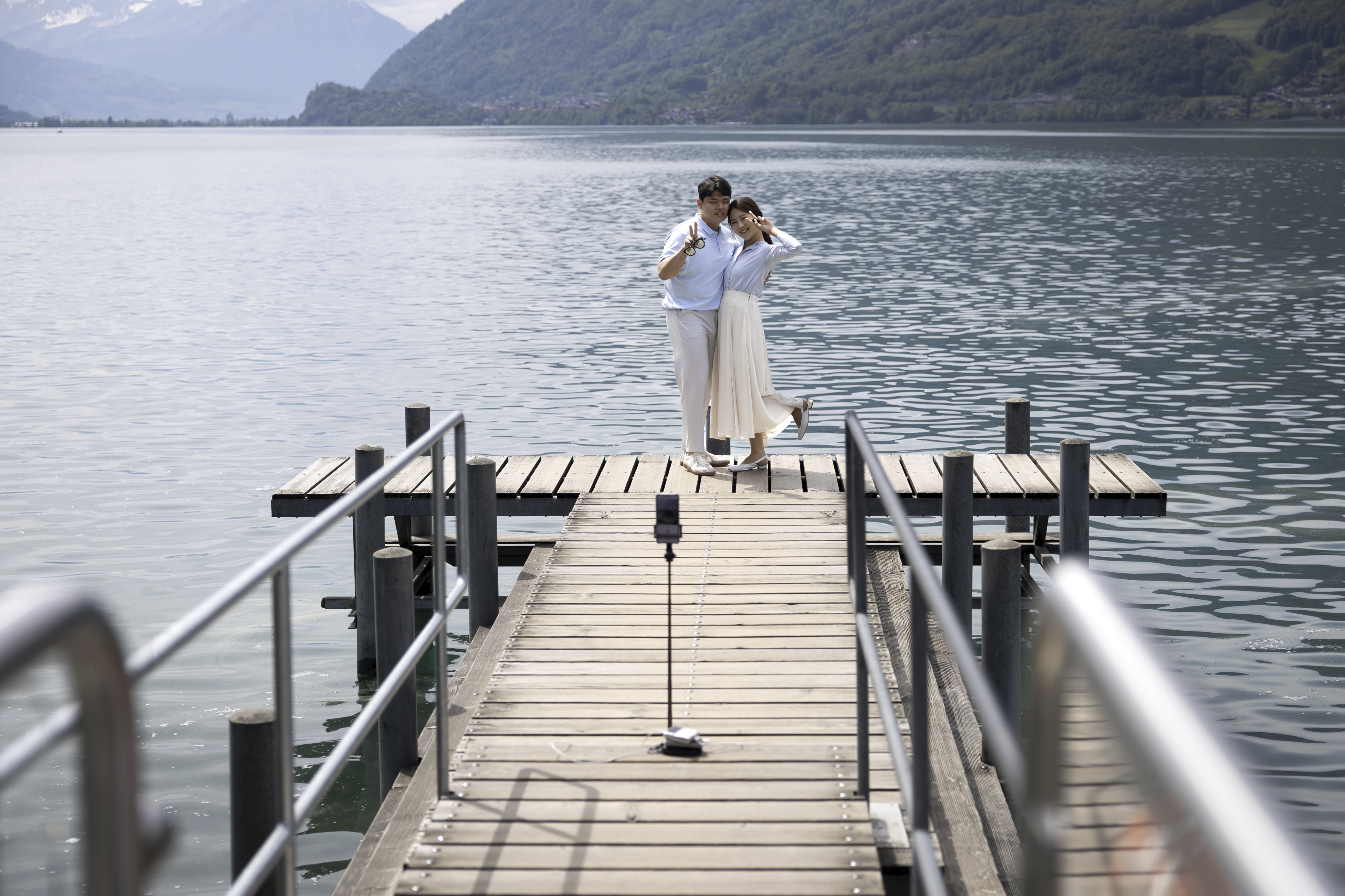 Korean visitors take pictures on the pier at Lake Brienz in Iseltwald, Switzerland, on May 21, 2023. The lakeside dock has seen an influx of tourists since featuring in the hit South Korean Netflix series Crash Landing On You. Photo: AP