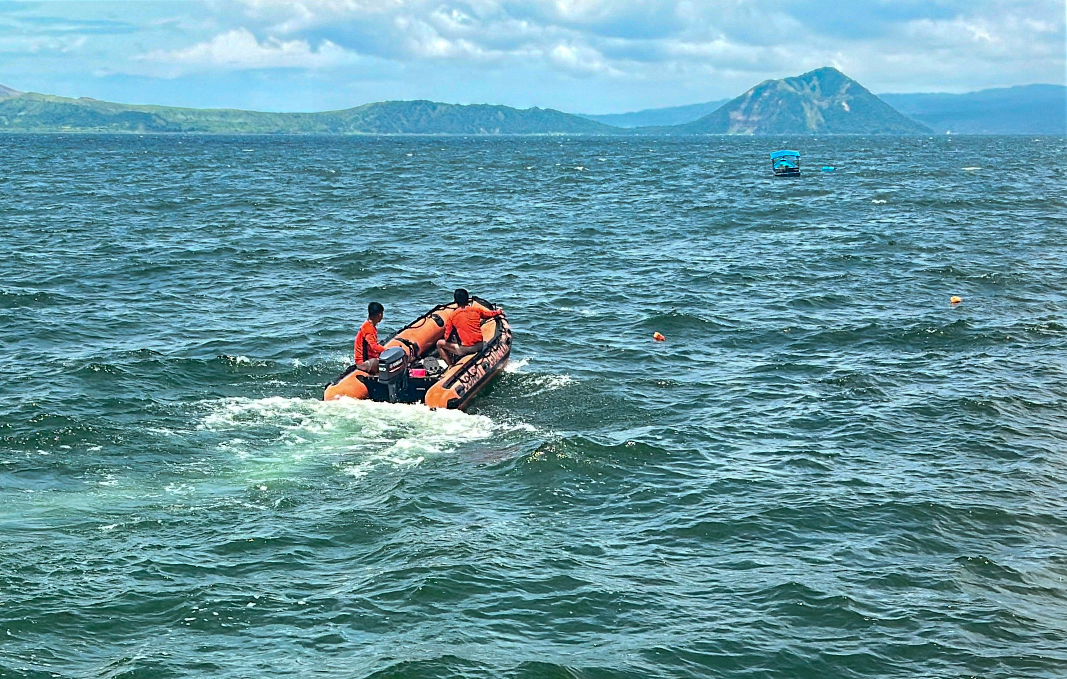 Philippine Coast Guard personnel scour Talisay waters on Thursday as divers prepare to search Lake Taal, where authorities hope to locate the bodies of missing cock fighters allegedly dumped in the area. Photo: Handout