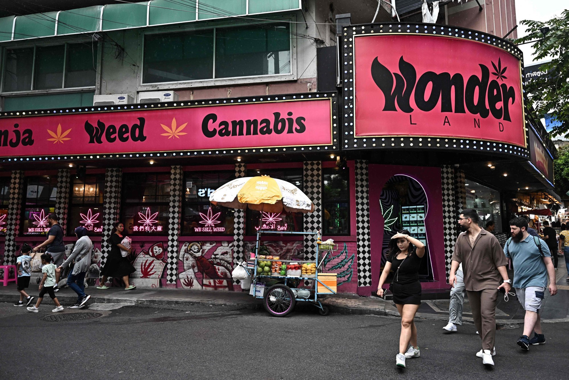 People walk past a cannabis dispensary in Bangkok. Photo: AFP People walk past a cannabis dispensary in Bangkok. Photo: AFP