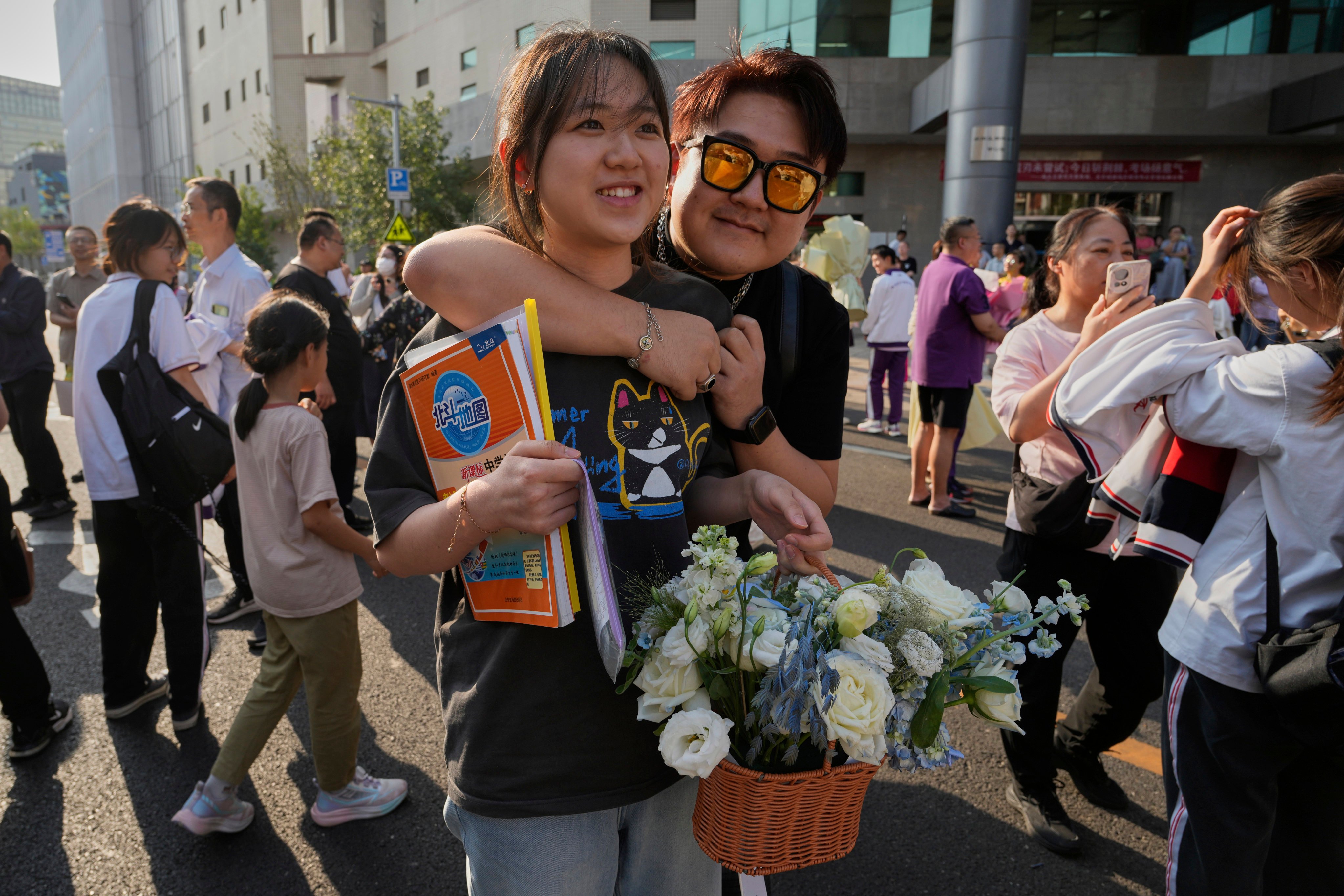 A high school student is hugged and presented with flowers after finishing the final day of the National Higher Education Entrance Examination in Beijing on June 10. Photo: AFP
