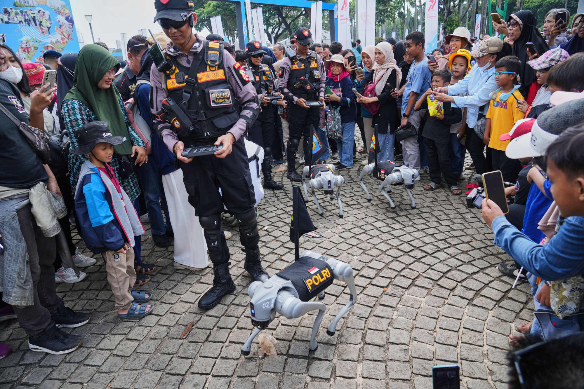 Police officers control their robodogs during the 79th anniversary celebration of Indonesia’s police in Jakarta on July 1. Photo: AP