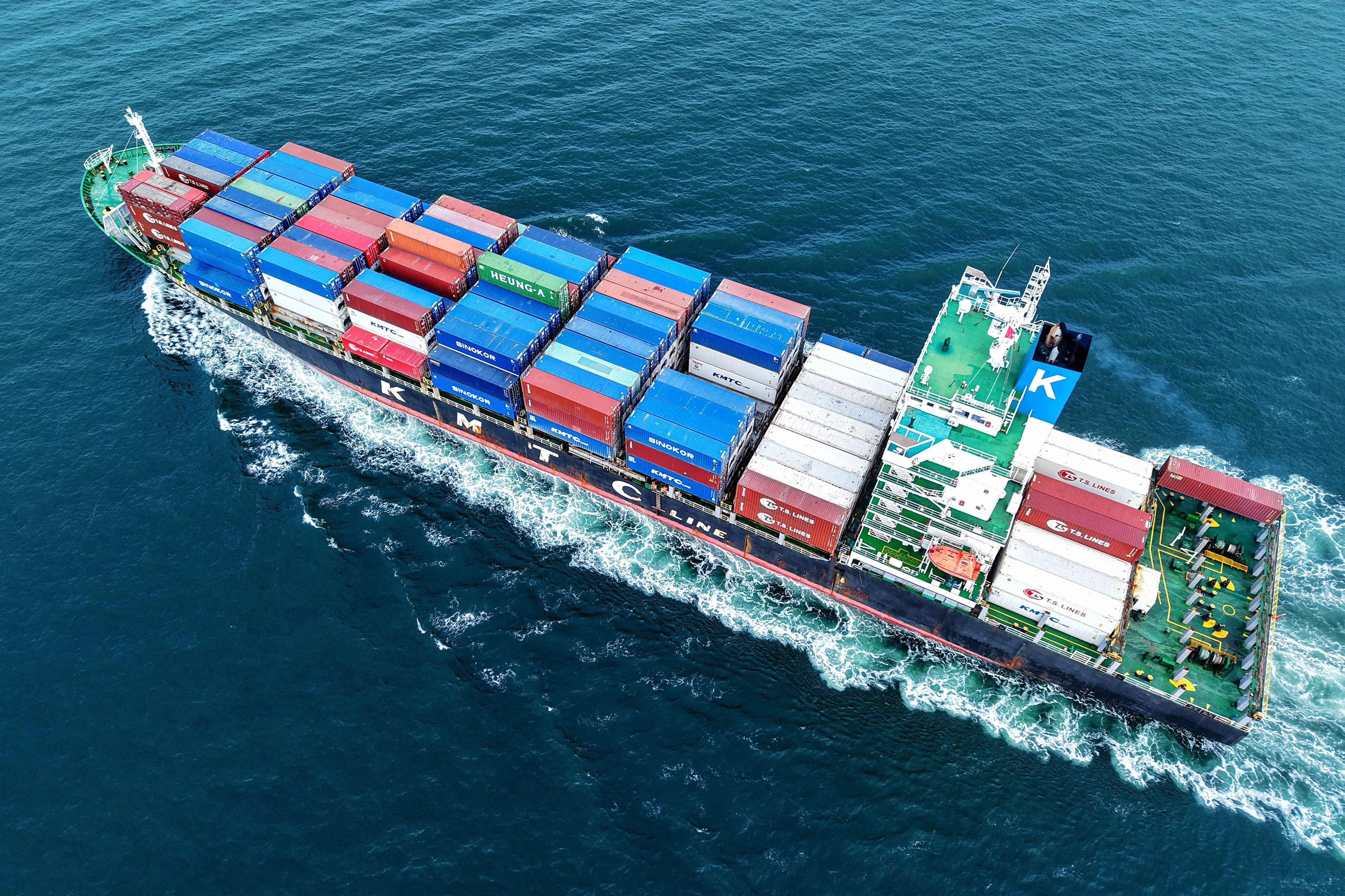 A cargo ship loaded with containers leaves the port in Qingdao, Shandong province, on Tuesday. Photo: AFP