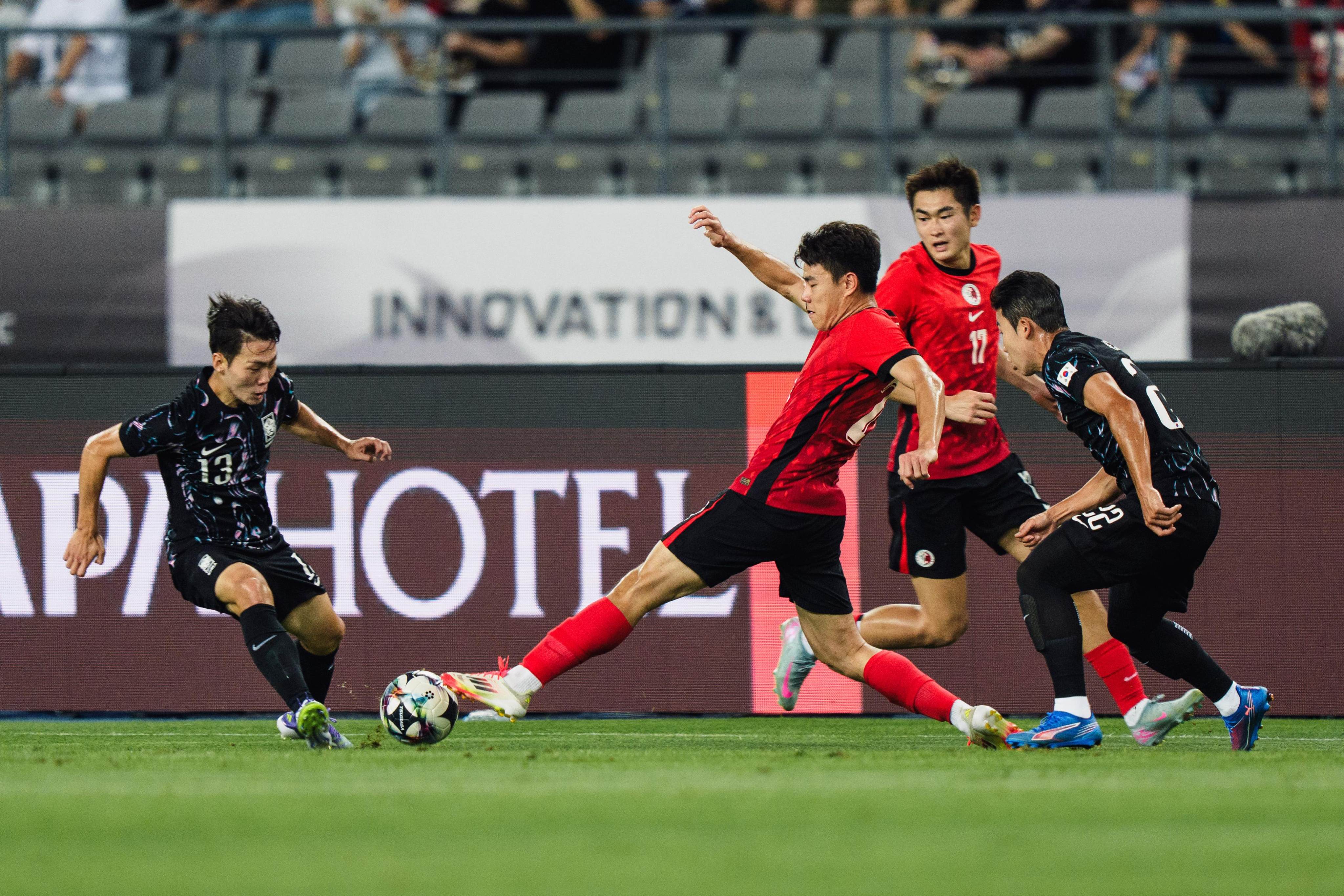 Sun Ming-him puts his foot in to challenge scorer Kang Sang-yoon. Photo: HKFA