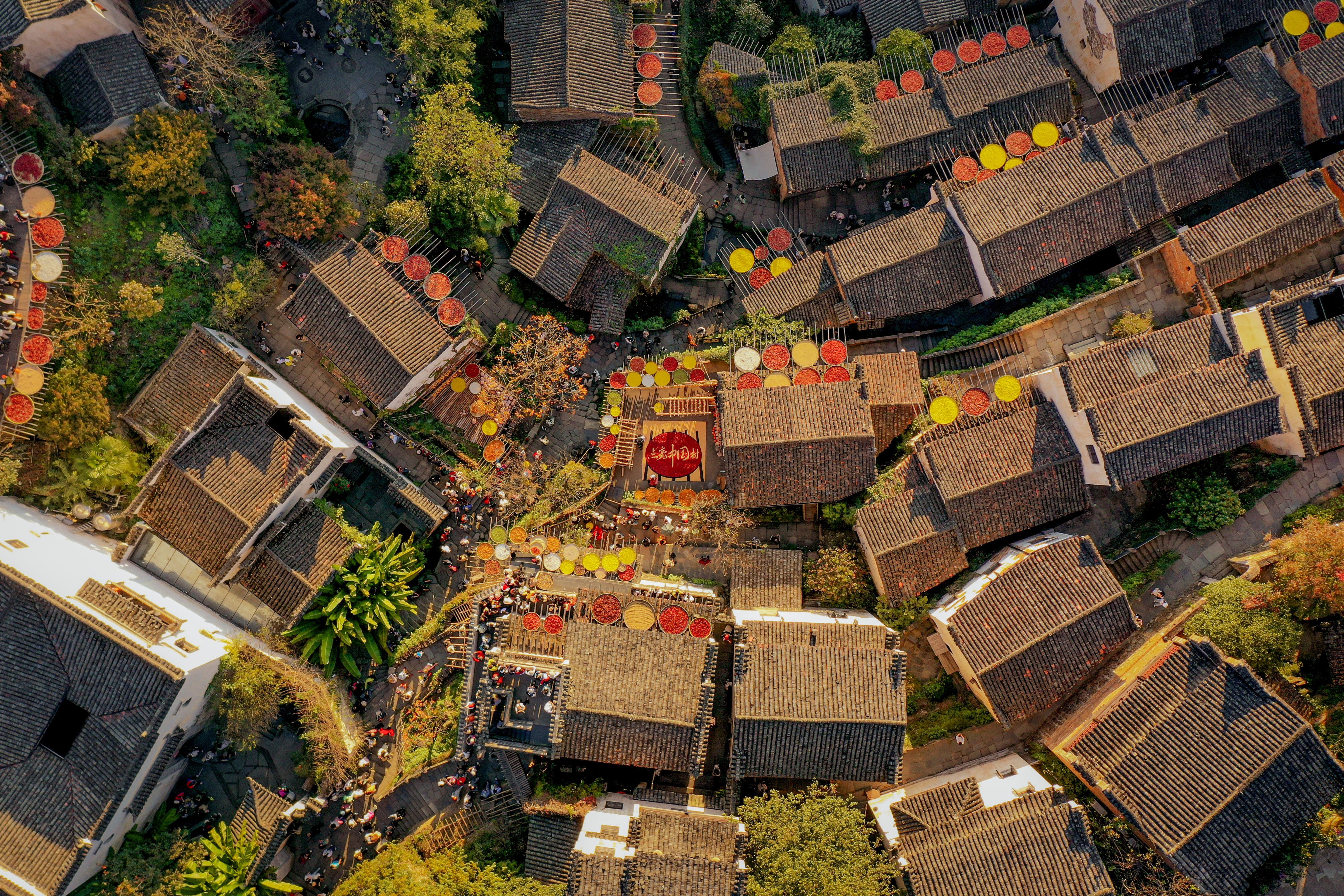 Bamboo baskets of chillies, corn and chrysanthemum petals dry in the sun in Huangling village, in China’s Jiangxi province. Photo: China News Service
