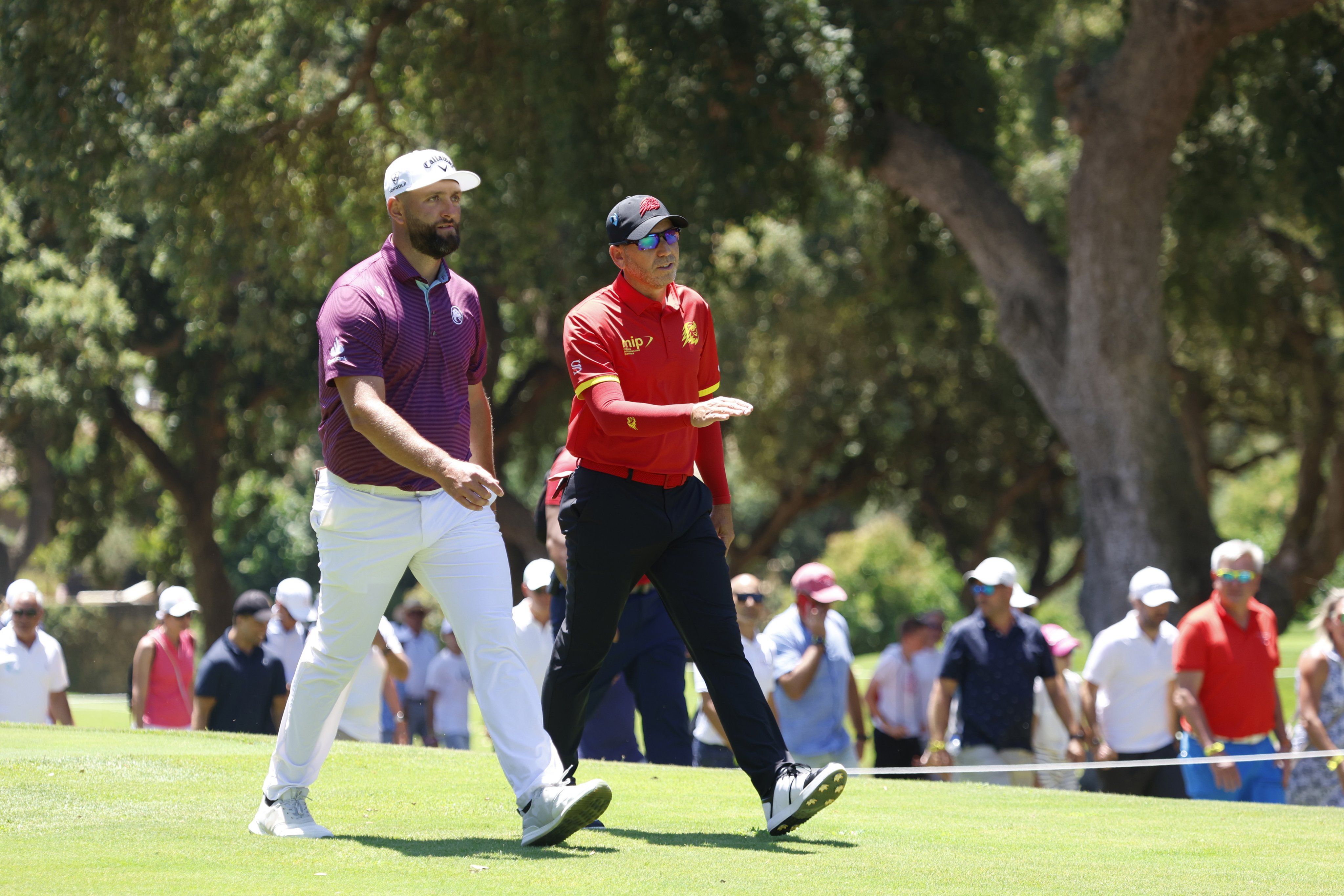 Jon Rahm (left) and Sergio Garcia walk down the fairway during the first day of the LIV Golf Andalusia. Photo: EPA