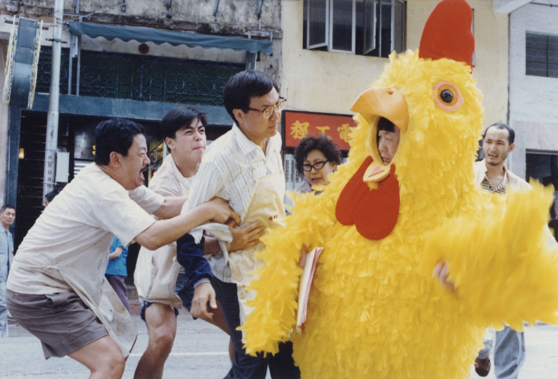 Michael Hui (in glasses and apron) and Ricky Hui (in chicken suit) in a still from Chicken and Duck Talk (1988). The Hui Brothers, which included Sam Hui, defined Hong Kong comedy in the 1970s with films like The Private Eyes, The Contract and Security Unlimited.