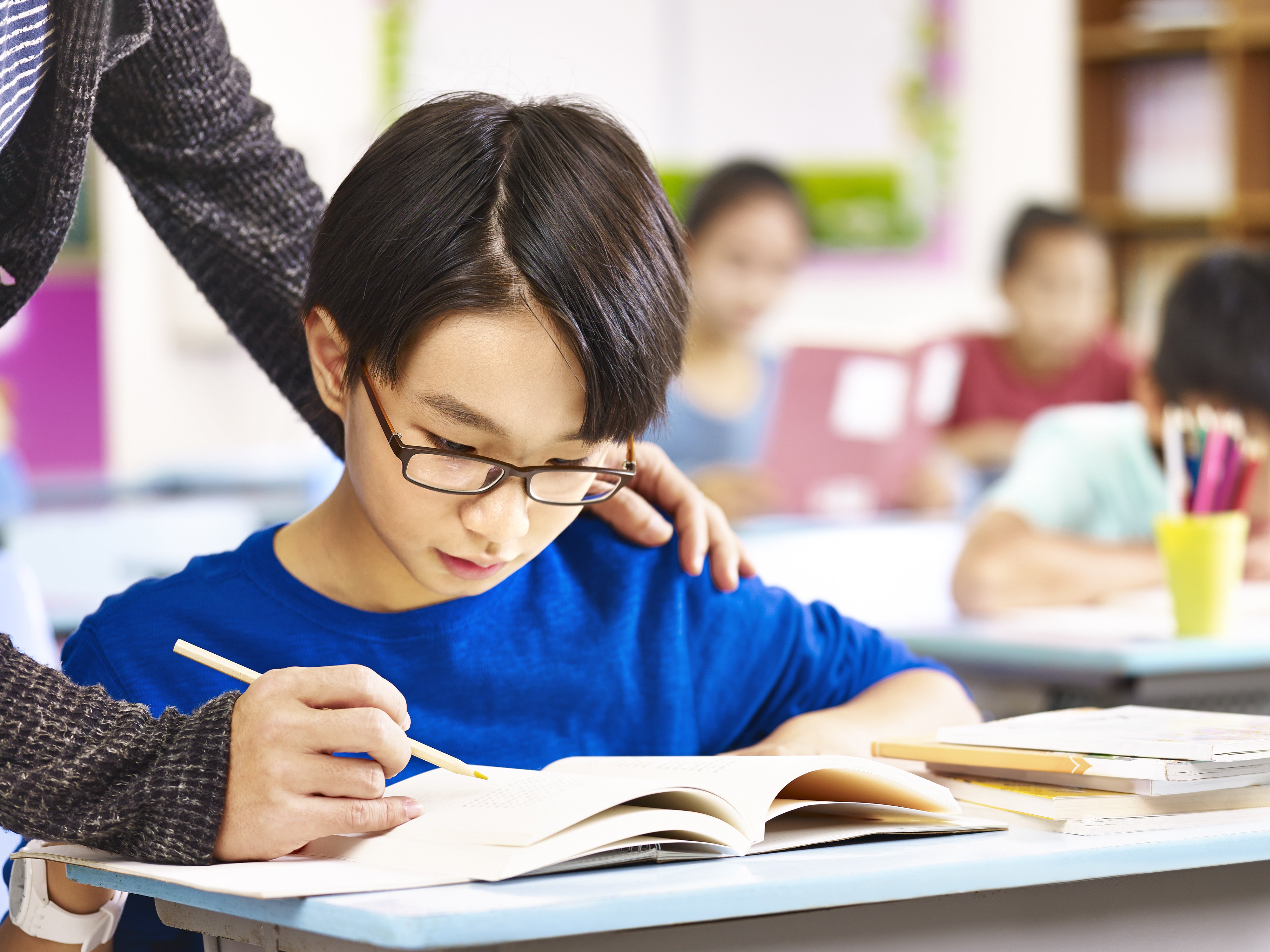 A student gets help from teacher in class. One of the most forceful condemnations of the proposed drama came from South Korea’s largest teaching union. Photo: Shutterstock