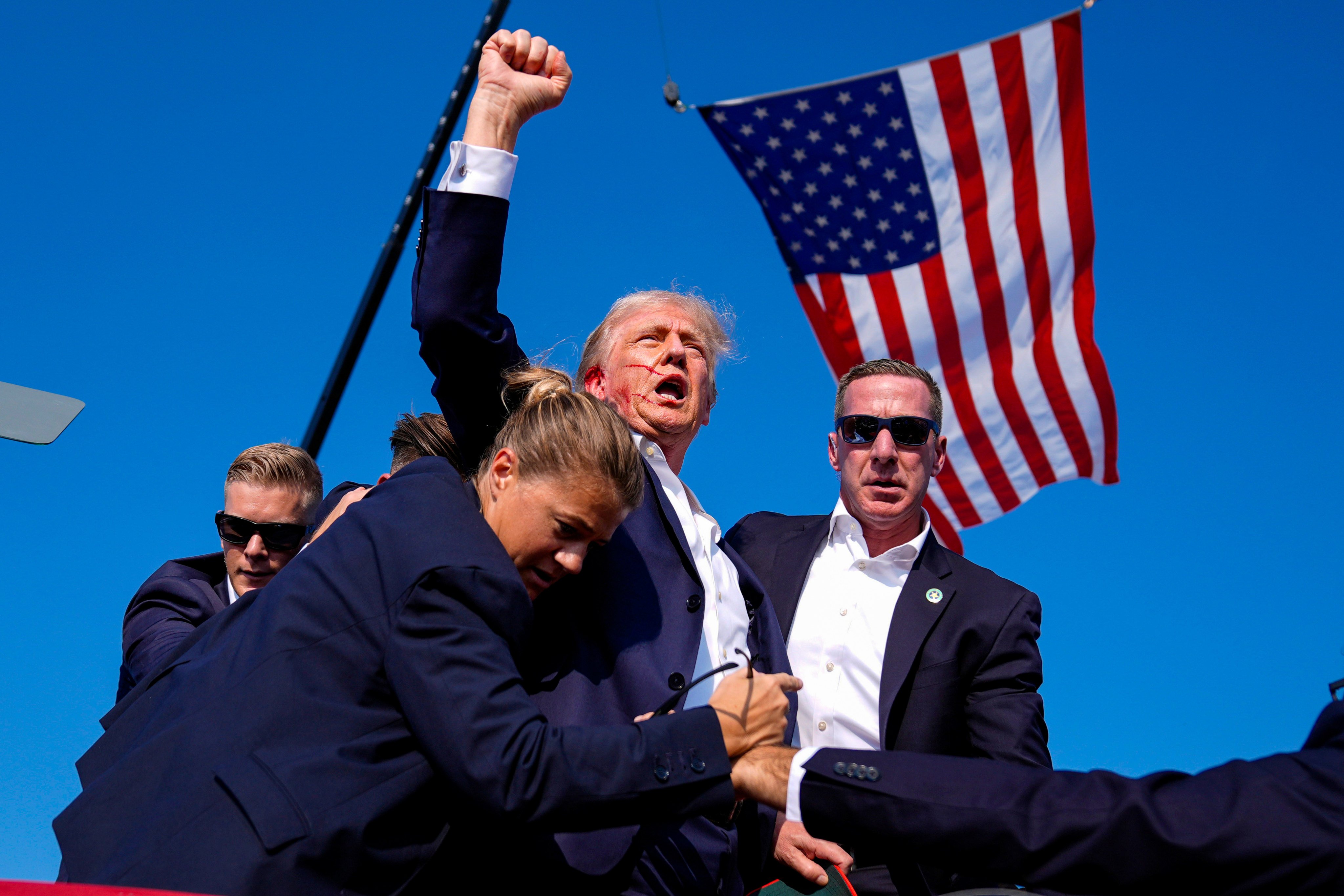 Donald Trump is surrounded by US Secret Service agents after an assassination attempt at a campaign rally in Butler, Pennsylvania, in July 2024. Photo: AP