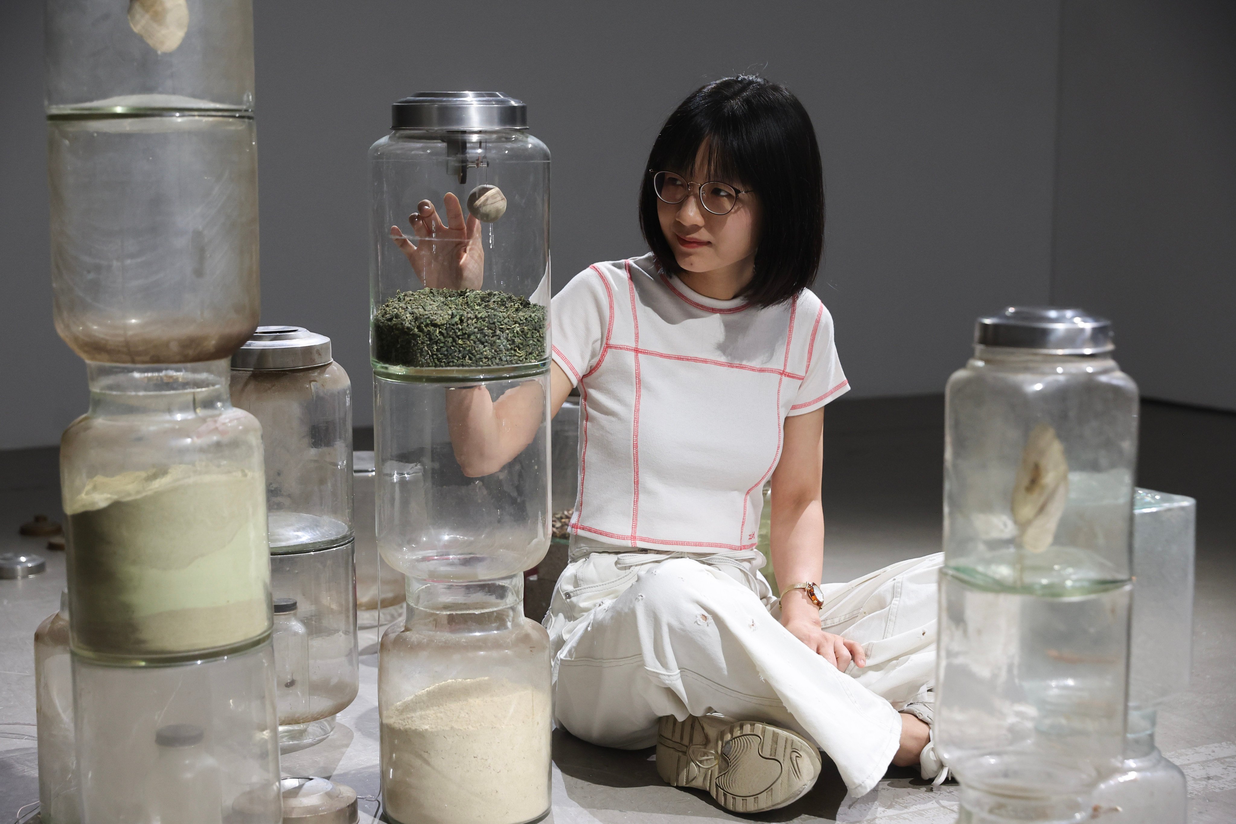 Hong Kong artist So Wing-po sits with her artwork Polyglot: Mulberry (2023) at her solo exhibition at Blindspot Gallery in Wong Chuk Hang, Hong Kong, on June 28, 2025. Photo: Edmond So