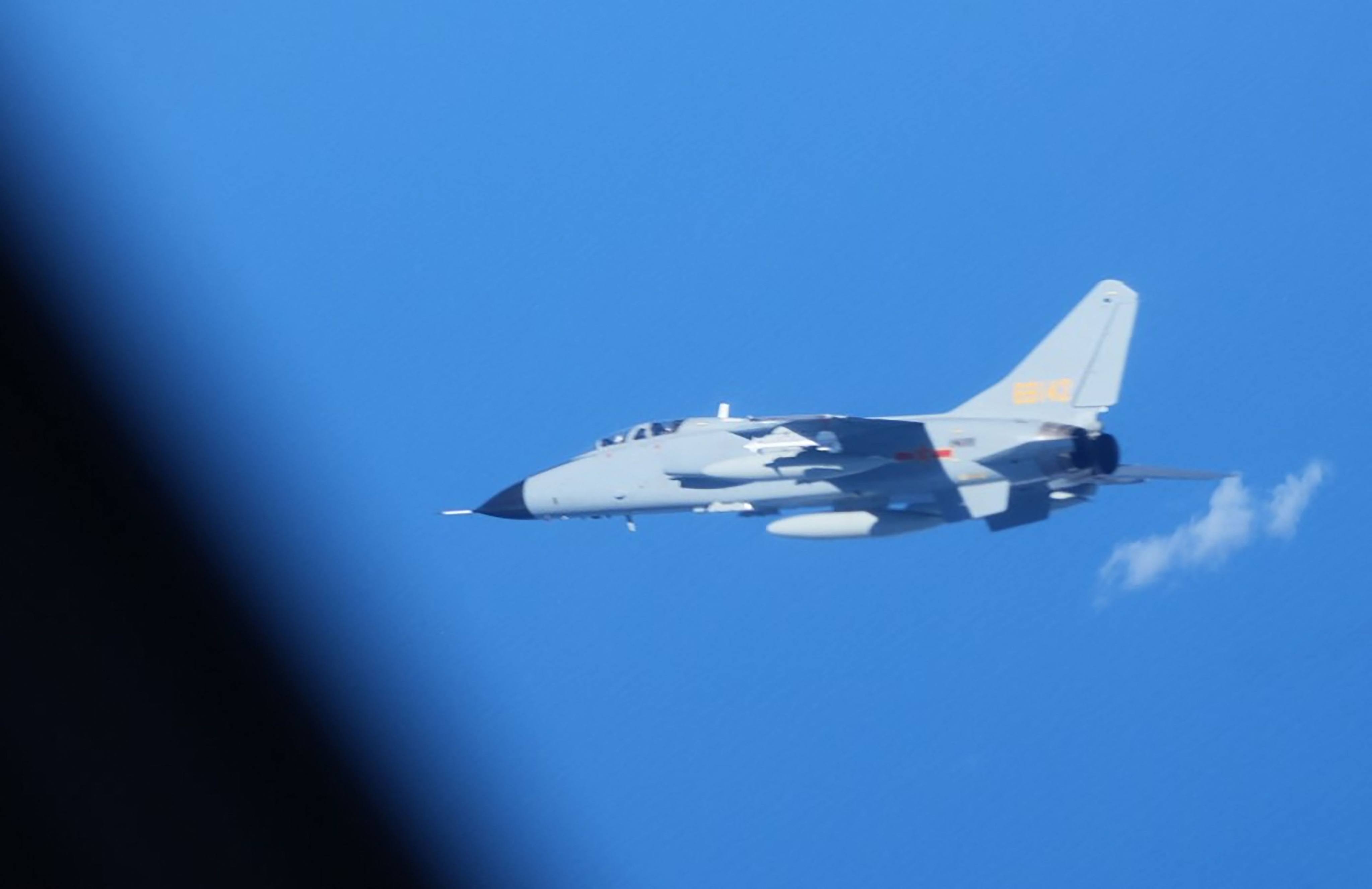 A Chinese JH-7 fighter-bomber flying close to a Japan Air Self-Defence Force YS-11EB intelligence-gathering aircraft on surveillance over the high seas in the East China Sea on July 9. Photo: Japan’s Ministry of Defence / AFP