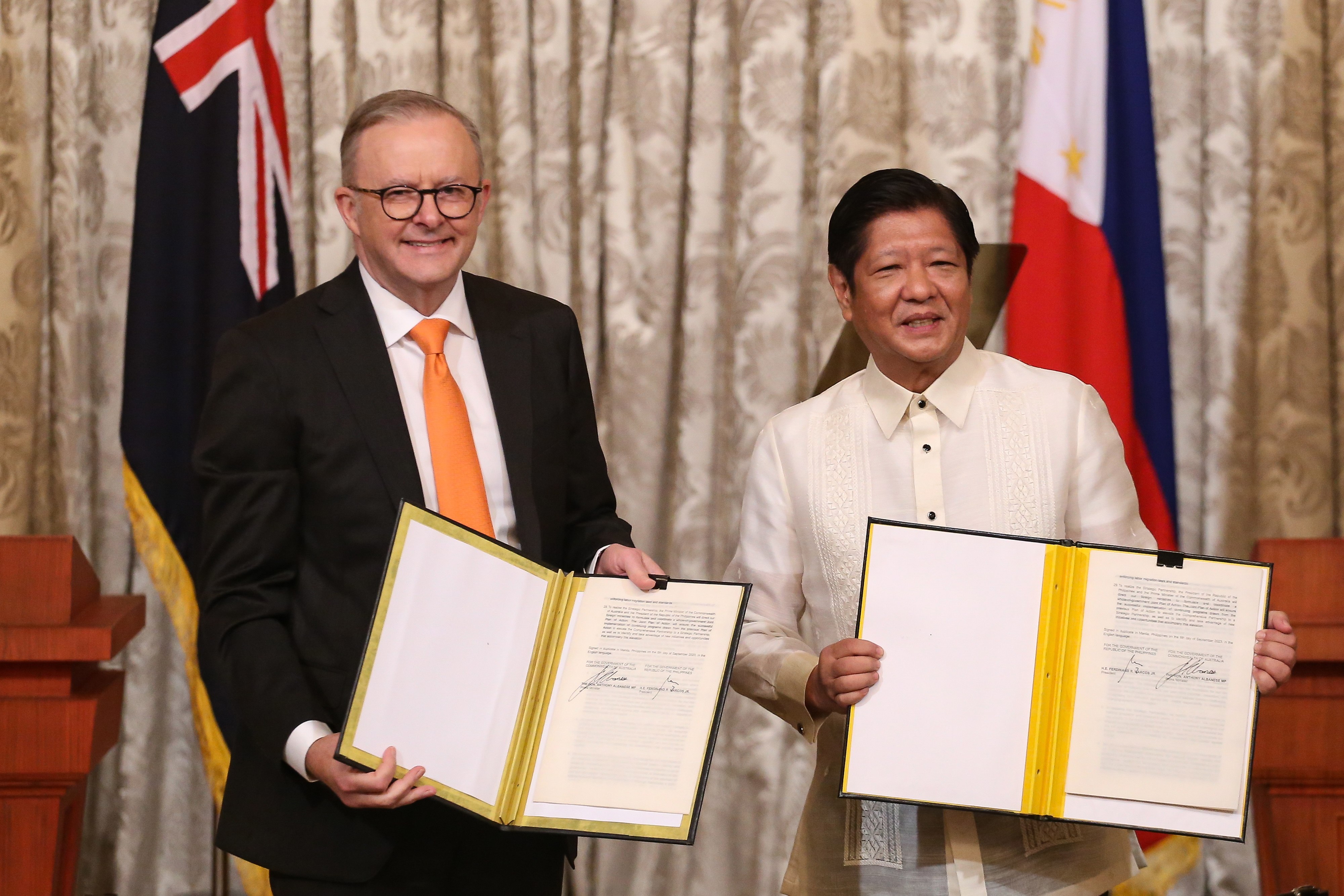 Australian Prime Minister Anthony Albanese and Philippine President Ferdinand Marcos Jnr display signed documents after upgrading bilateral relations in 2023. Photo: EPA-EFE