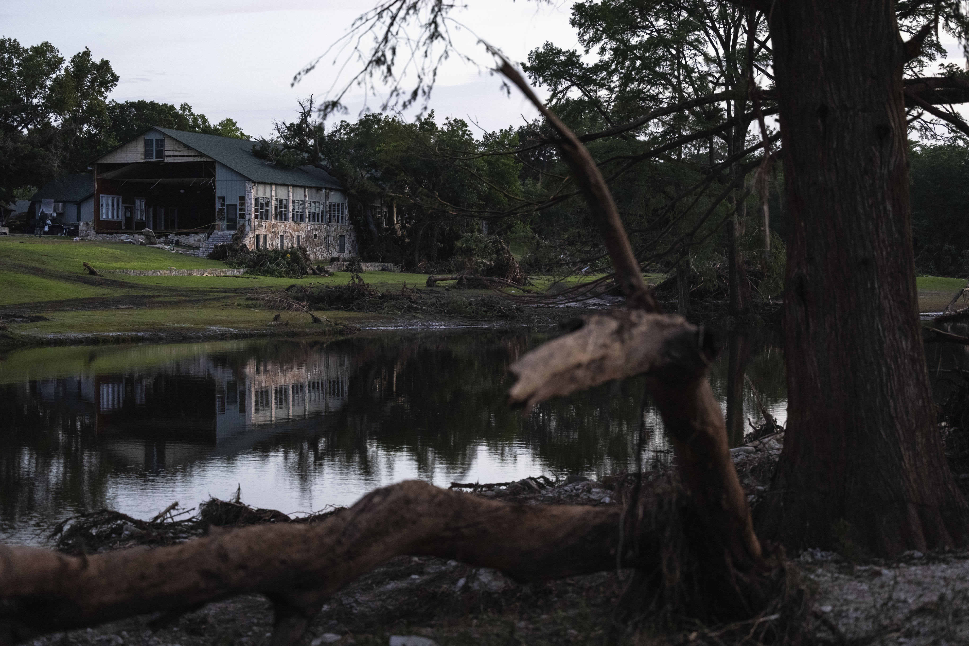 A building at Camp Mystic is reflected in water after a flash flood swept through the area July 7, in Hunt, Texas. Photo: AP