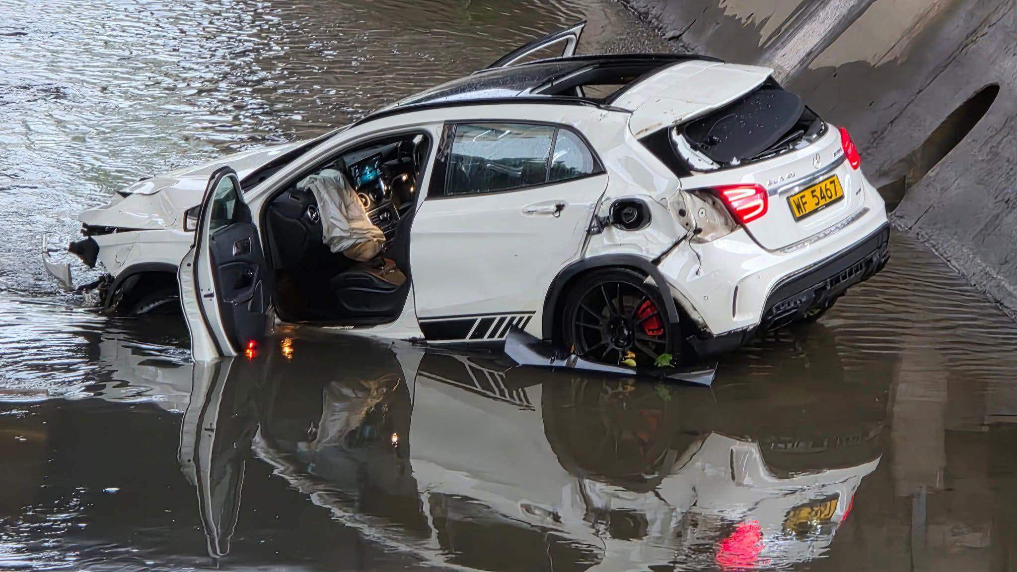 The Mercedes-Benz is sitting in a drainage channel in Yuen Long.  Photo: Handout