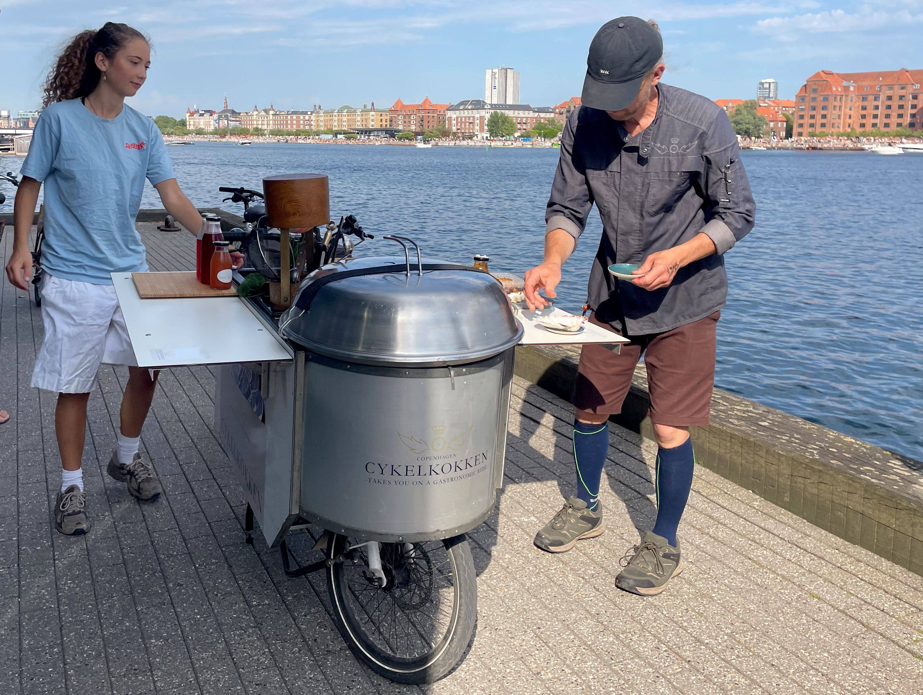 Danish chef Morten Kryger Wulff cooks on his self-designed kitchen-bike during a stop of a  gastronomical bike tour on July 2 in Copenhagen, Denmark. Photo: AFP
