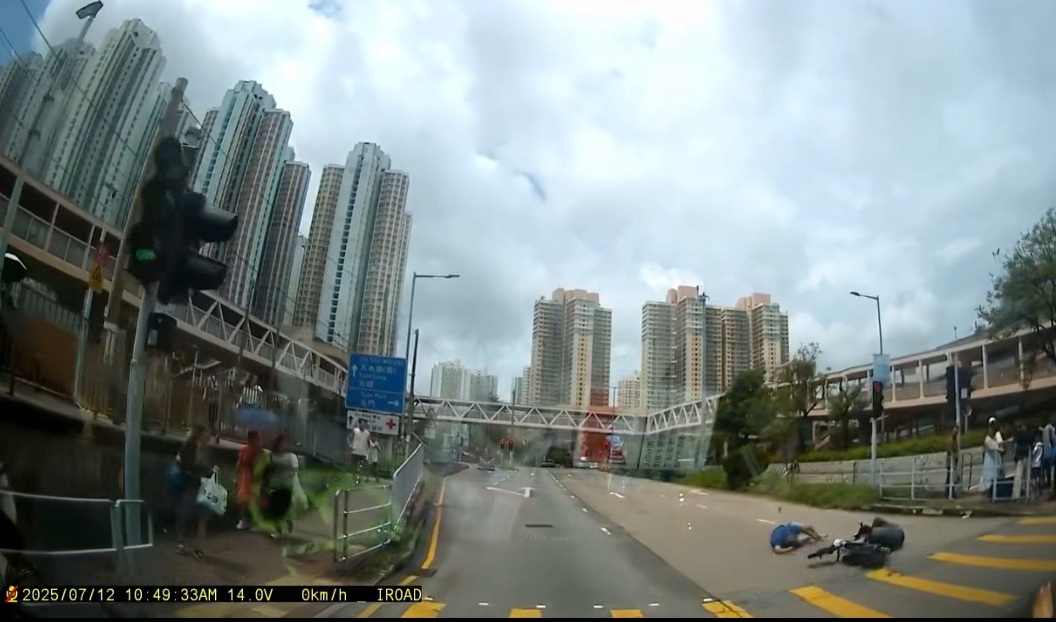 A screengrab of footage circulating online shows the pedestrian (in blue top) and the rider both lying on the road. Photo: Facebook/Steve Yeung