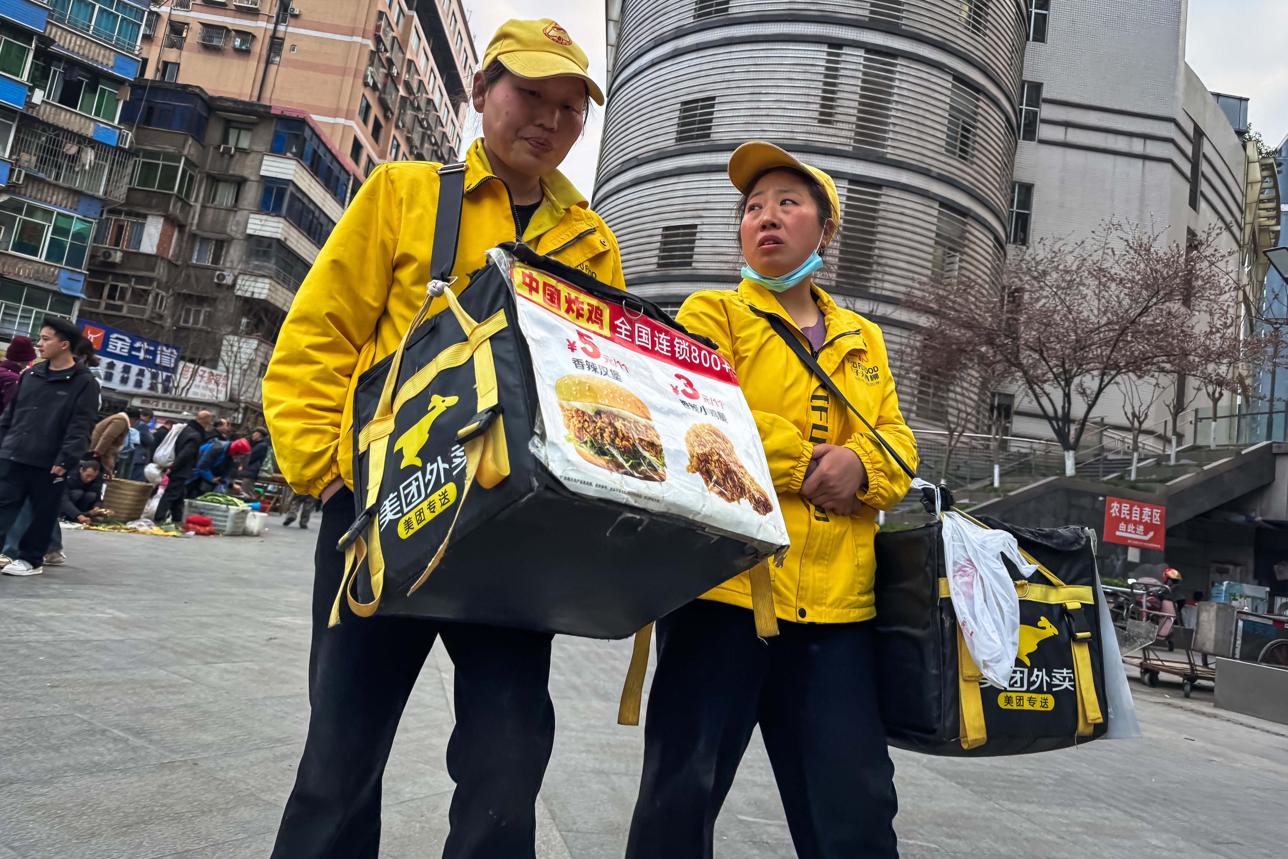 Meituan food delivery workers promote meal discounts in Chongqing, China. Photo: Getty Images