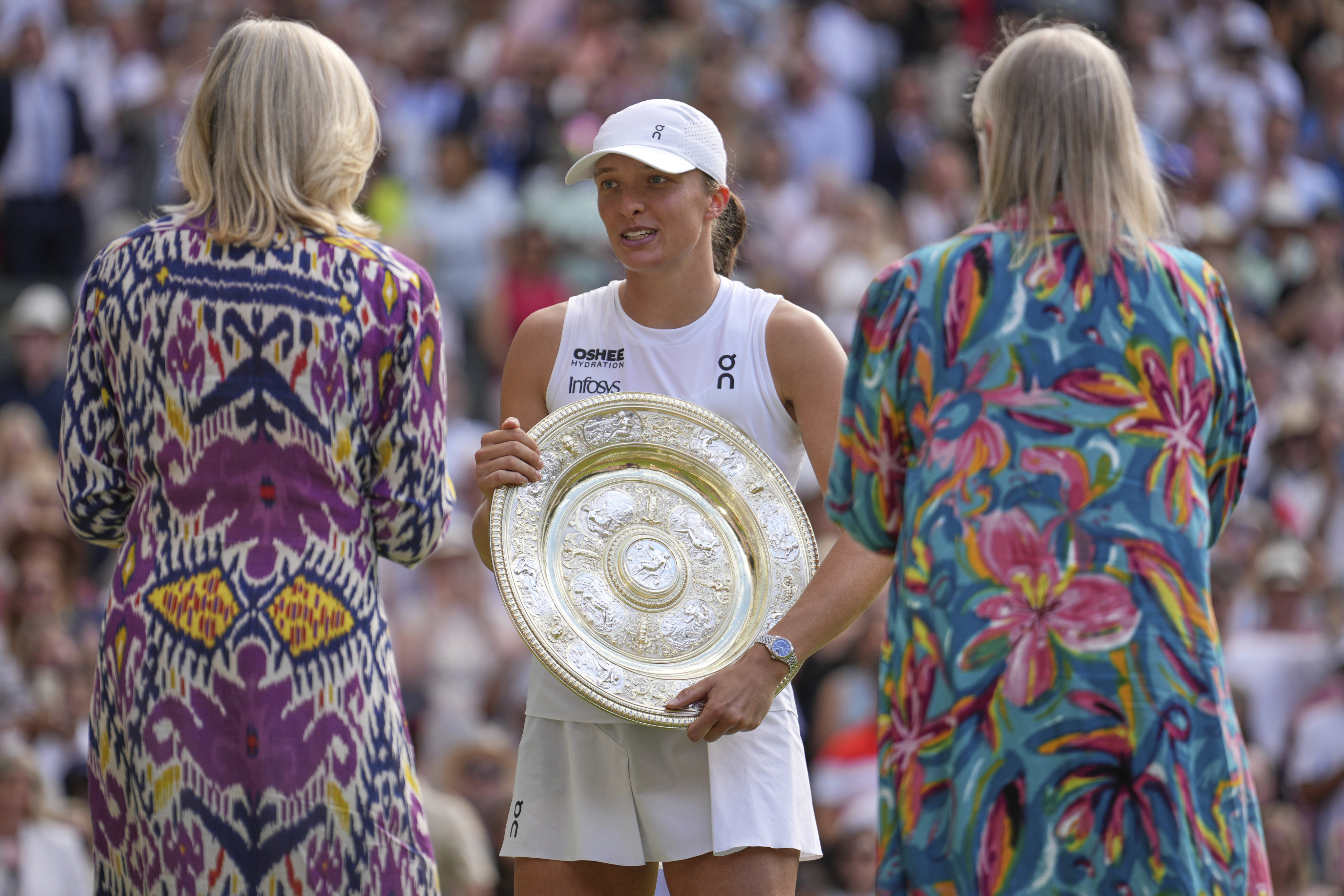 Poland’s Iga Swiatek celebrates with the trophy after the women’s singles final at the Wimbledon Tennis Championships in London, on Saturday. Photo: AP