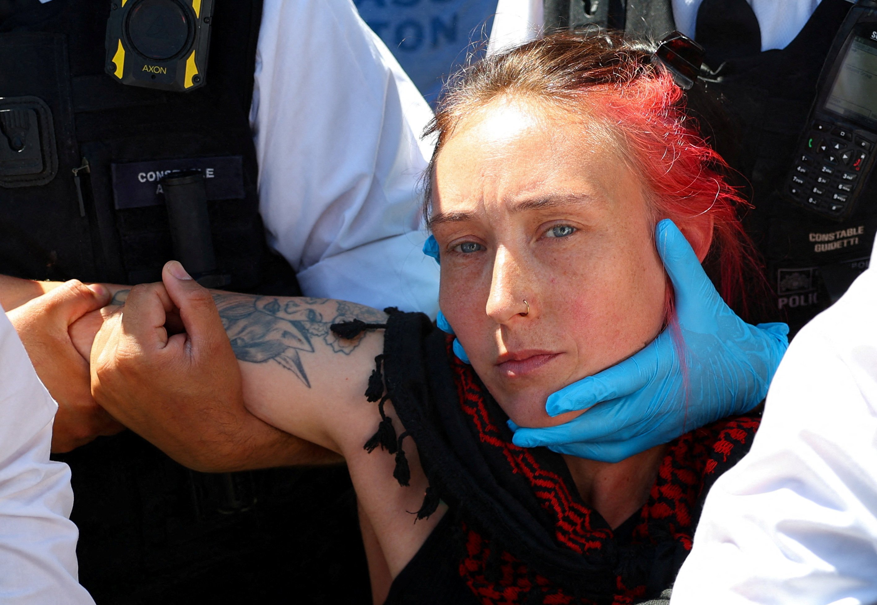 Police officers detain a protester during a demonstration in London on Saturday. Photo: Reuters
