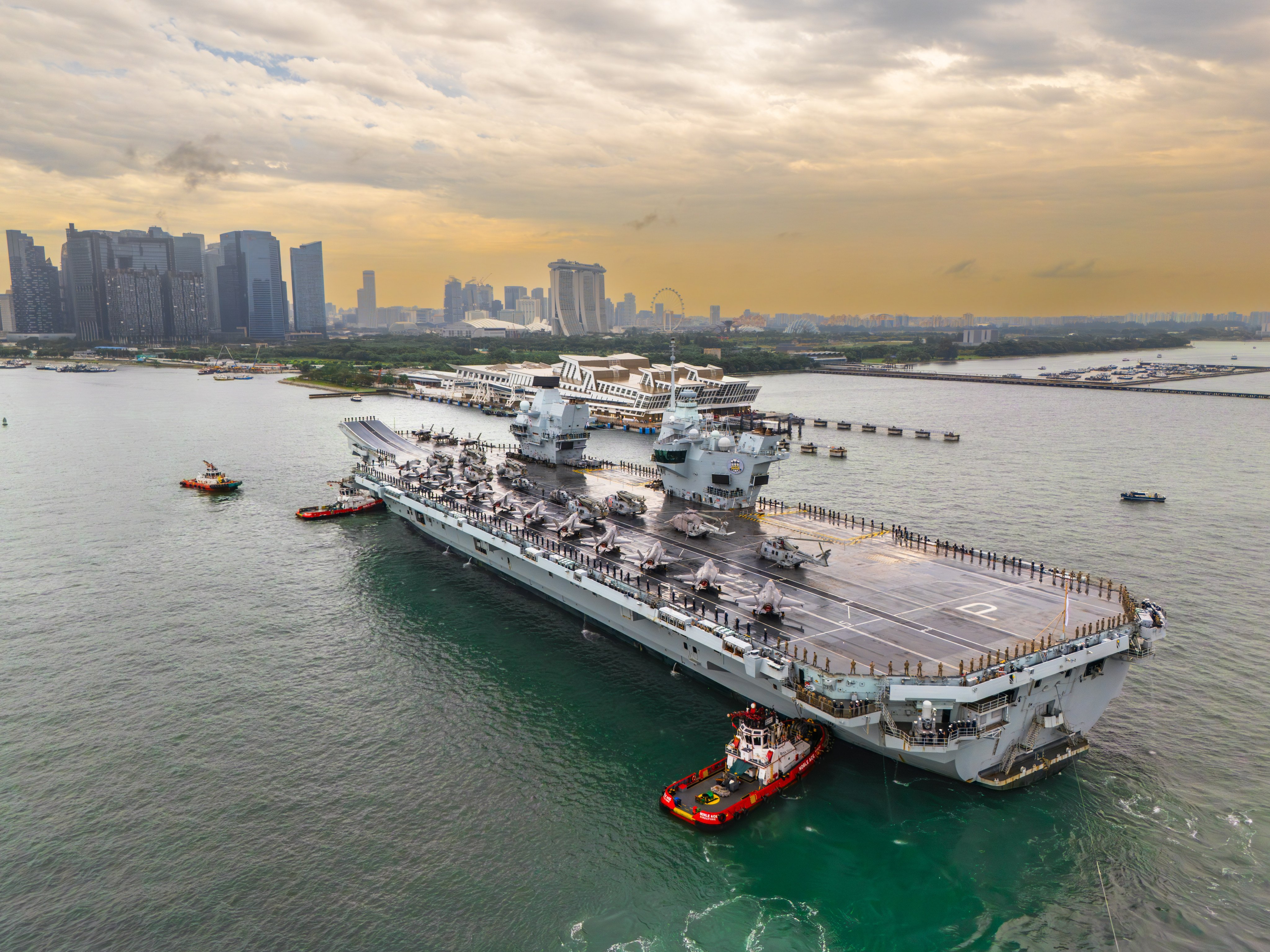 HMS Prince of Wales became the first warship to dock at the Marina Bay Cruise Centre in Singapore on June 23. It hosted public tours and a defence and security expo with British companies. Photo: Handout