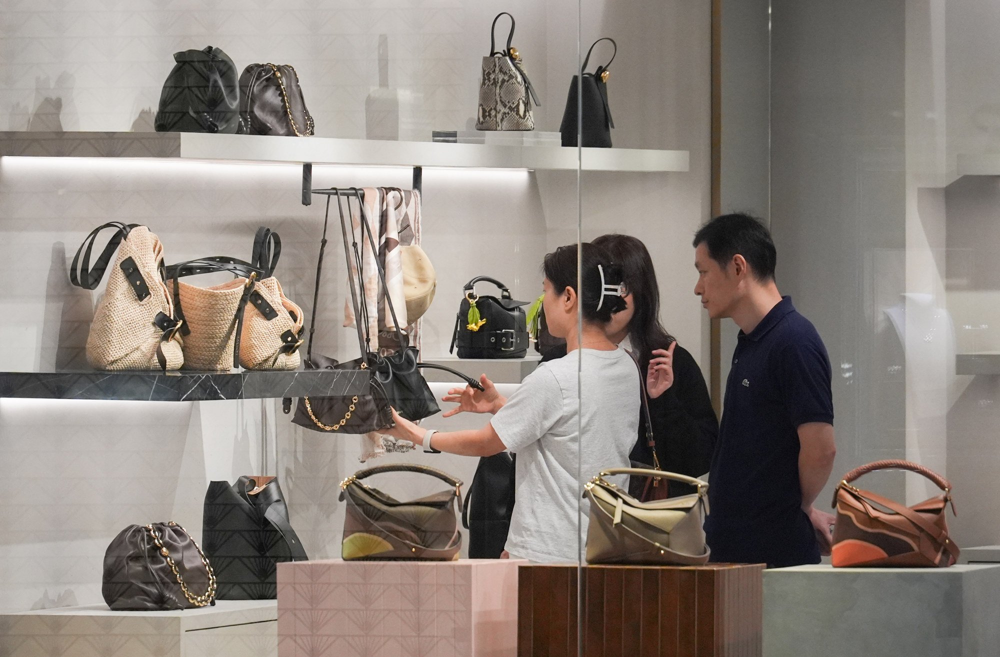 Customers browse for luxury goods at a shop in Tsim Sha Tsui. Photo: Eugene Lee Customers browse for luxury goods at a shop in Tsim Sha Tsui. Photo: Eugene Lee