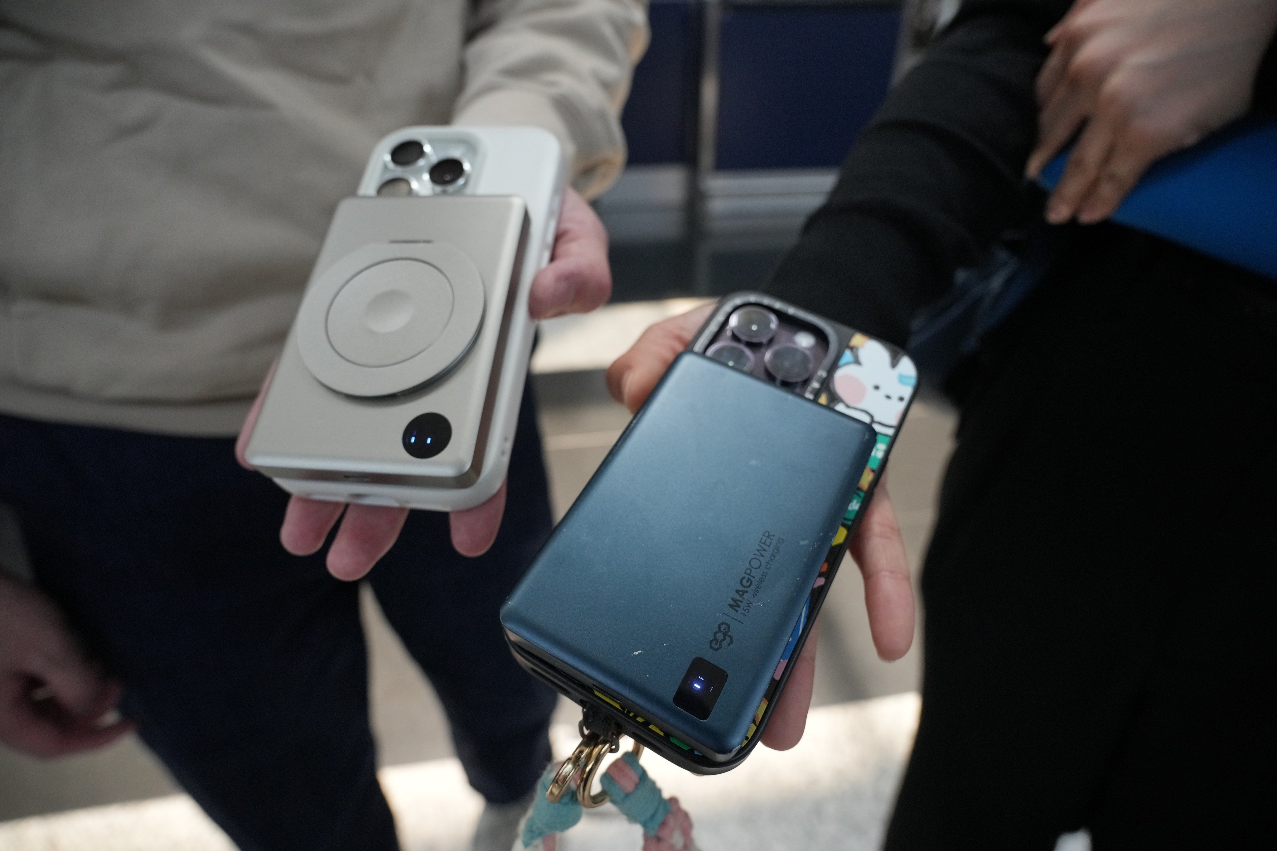 Passengers hold out their portable power banks at the departure hall of Hong Kong International Airport on April 7. Photo: May Tse