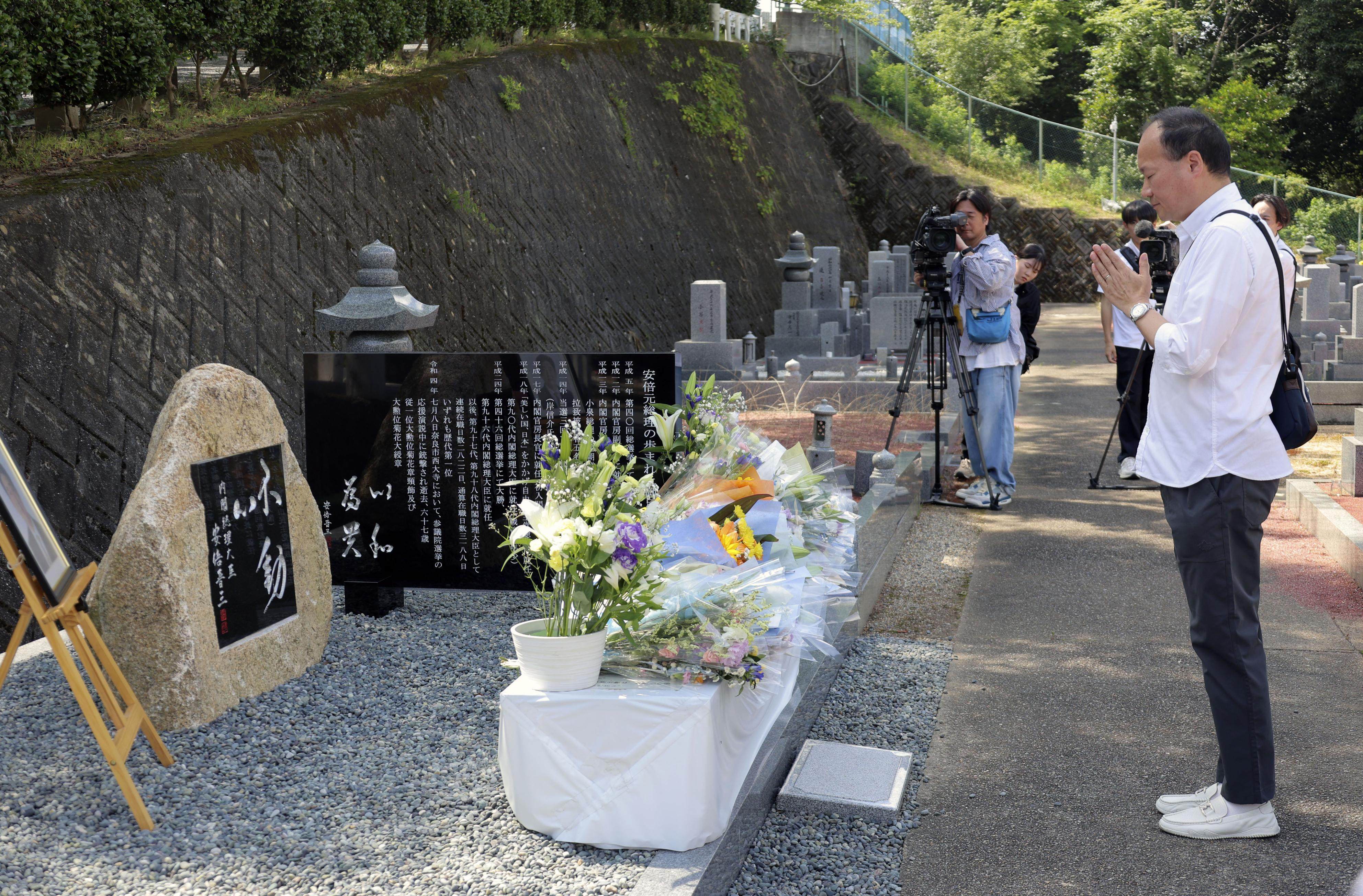 A man prays at a stone monument dedicated to former Japanese prime minister Shinzo Abe in a cemetery in Nara. Photo: Kyodo