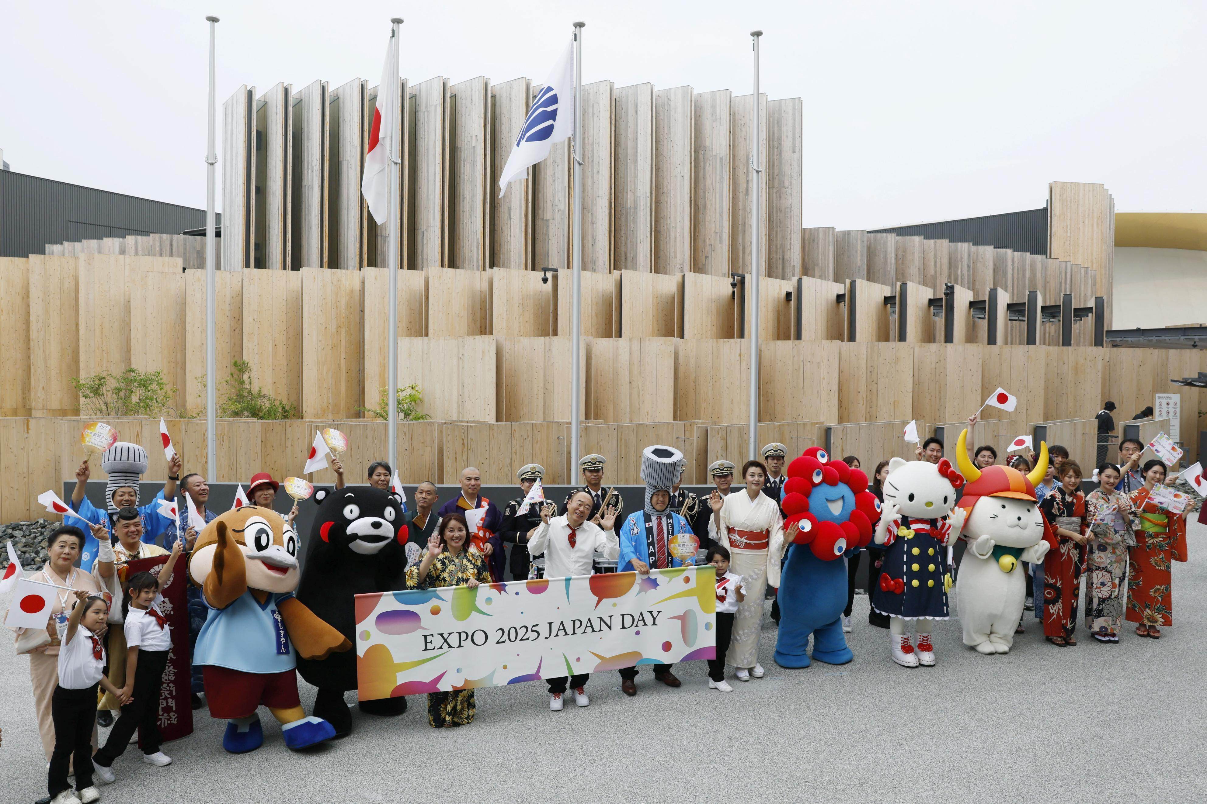 Mascots and expo staff pose for a photo in front of the Japan Pavilion at the World Expo in Osaka on July 3. Photo: Kyodo