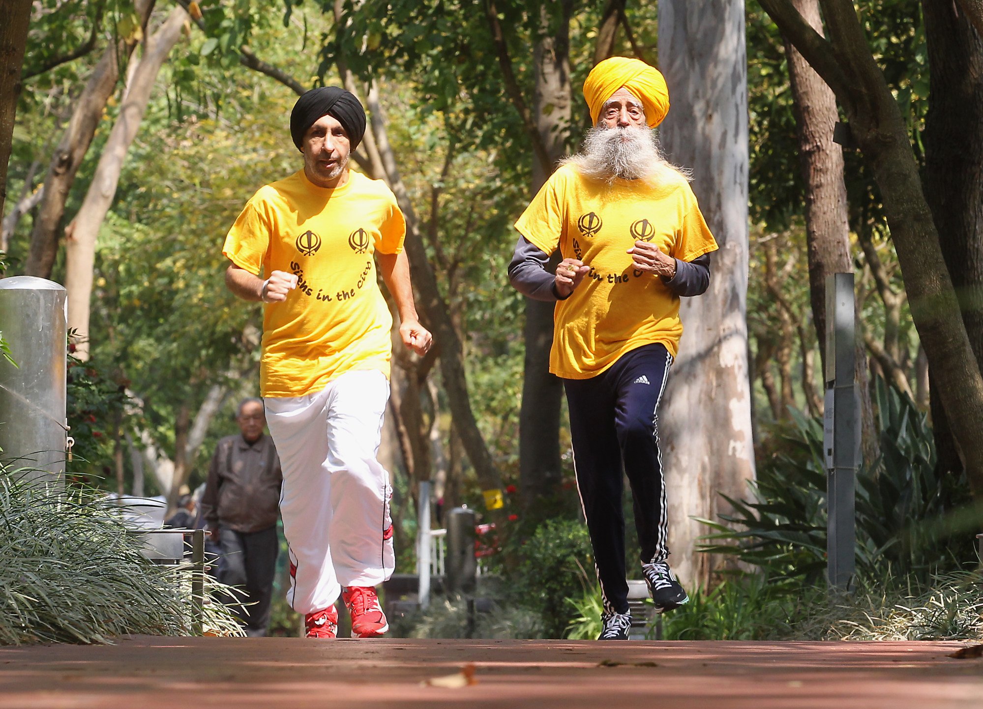 Fauja Singh, then 101, runs in Victoria Park with coach Haemander Singh in Causeway Bay ahead of a 10km race at the 2013 Hong Kong Marathon event. Photo: K. Y. Cheng Fauja Singh, then 101, runs in Victoria Park with coach Haemander Singh in Causeway Bay ahead of a 10km race at the 2013 Hong Kong Marathon event. Photo: K. Y. Cheng