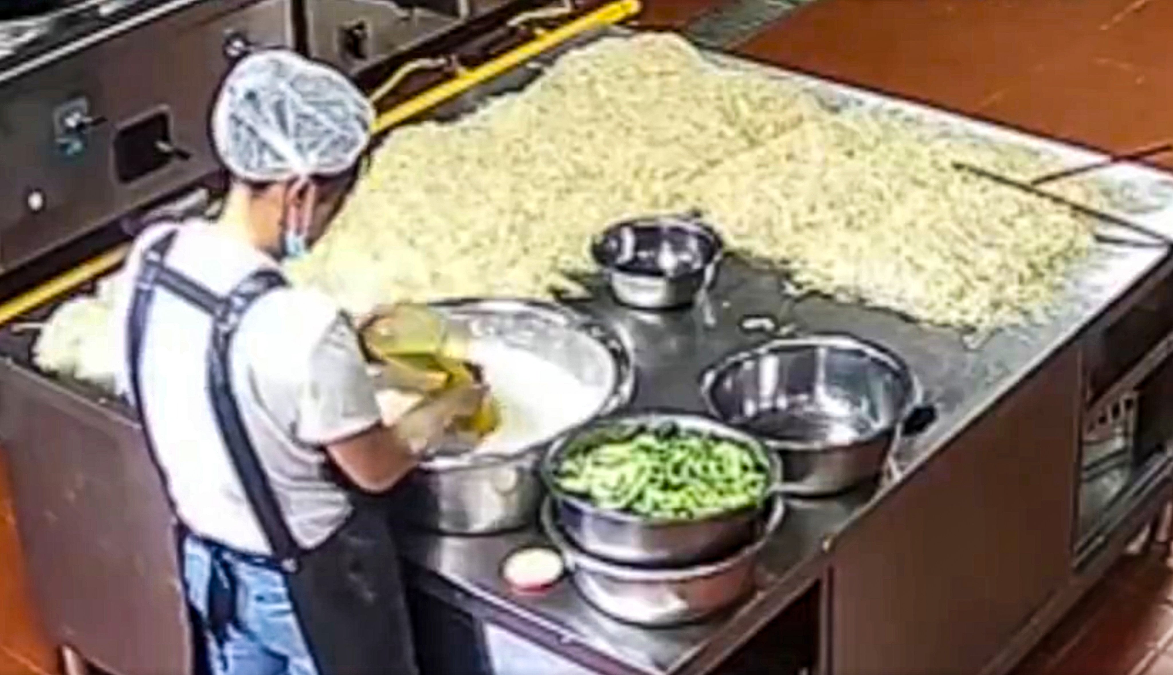 A screenshot of footage of kitchen staff at a Gansu kindergarten where children have fallen ill with lead poisoning.  Photo: handout