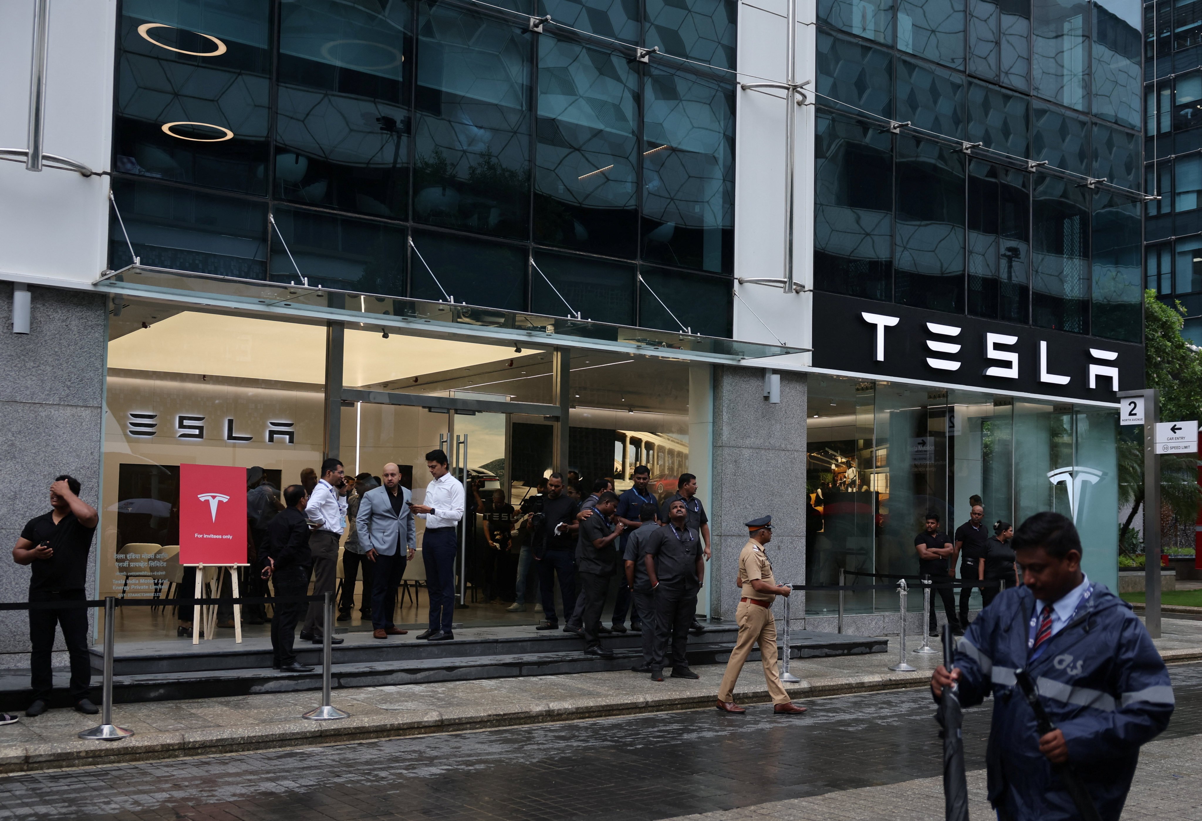 People are seen outside the Tesla showroom ahead of its opening in Mumbai, India, on Tuesday. Photo: Reuters
