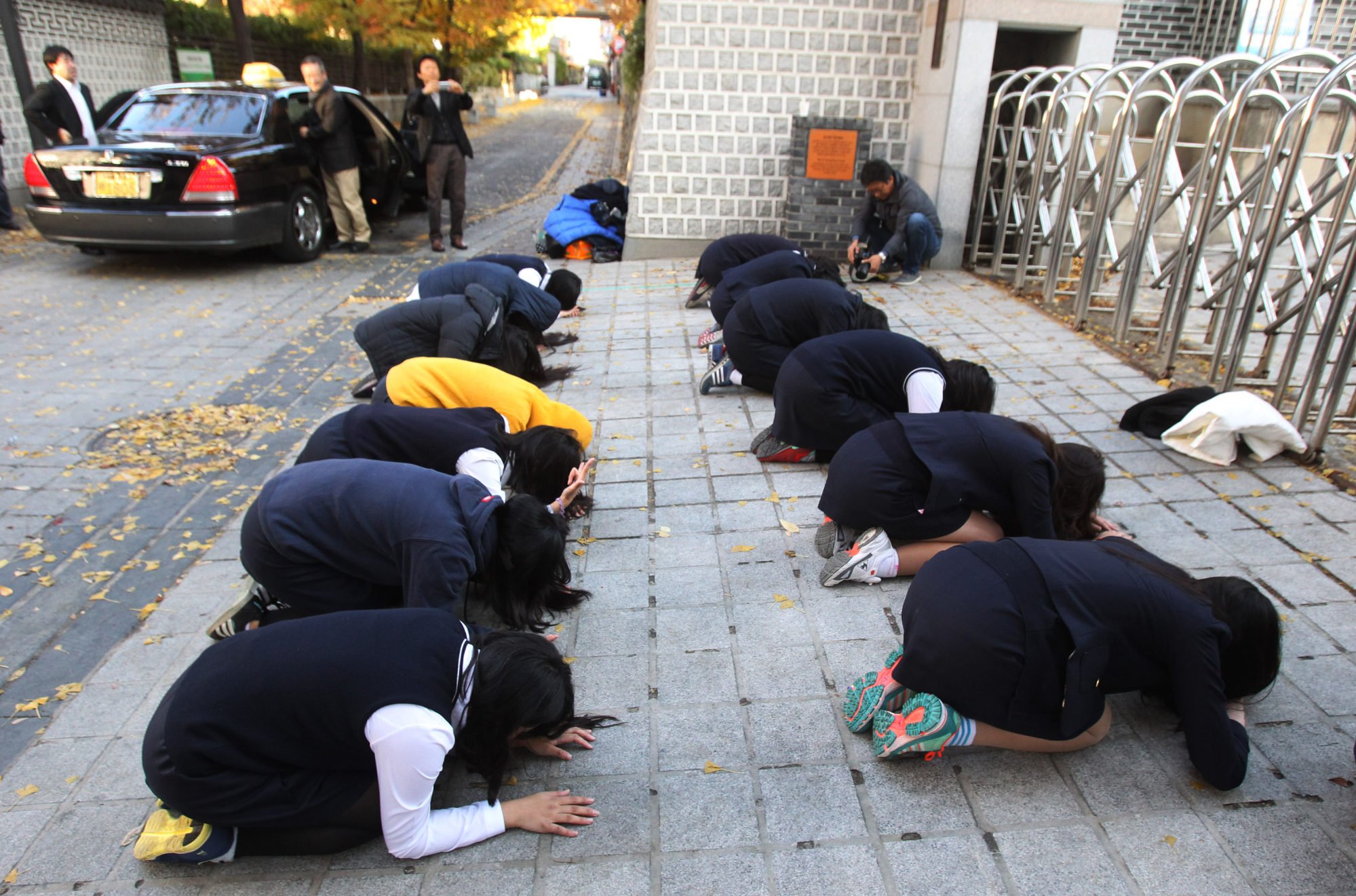 South Korean students bow to pray for their seniors’ success in the Scholastic Aptitude Test in front of an examination hall in Seoul. Photo: AP South Korean students bow to pray for their seniors’ success in the Scholastic Aptitude Test in front of an examination hall in Seoul. Photo: AP
