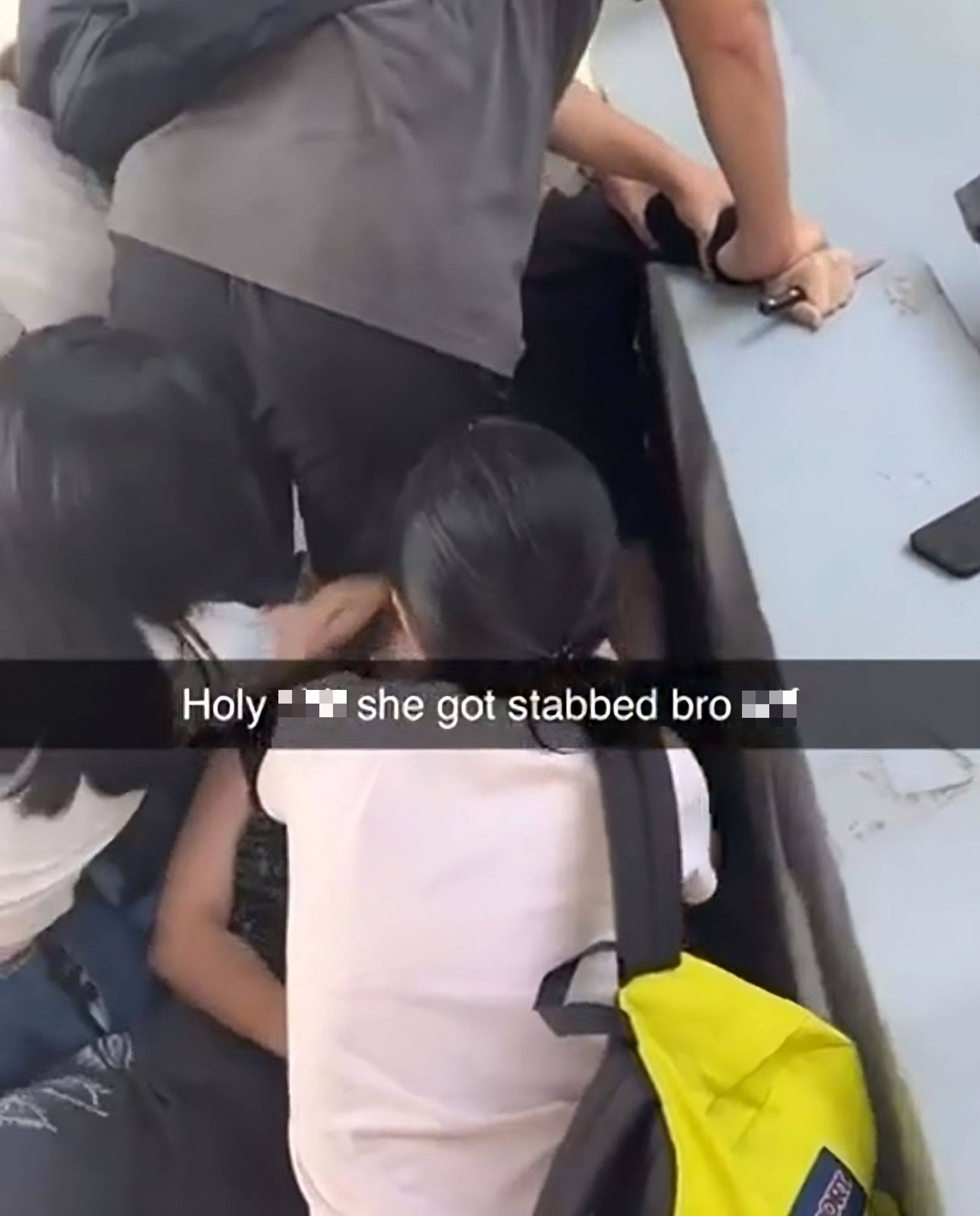 A screengrab of a social media video shows the suspect being restrained as friends try to help the victim following the knife attack. Photo: Reddit