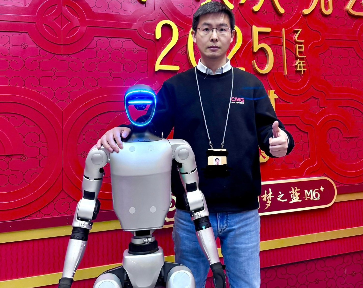Unitree Robotics founder and CEO Wang Xingxing stands beside one of the firm’s G1 humanoid robots in January. Photo: Unitree
