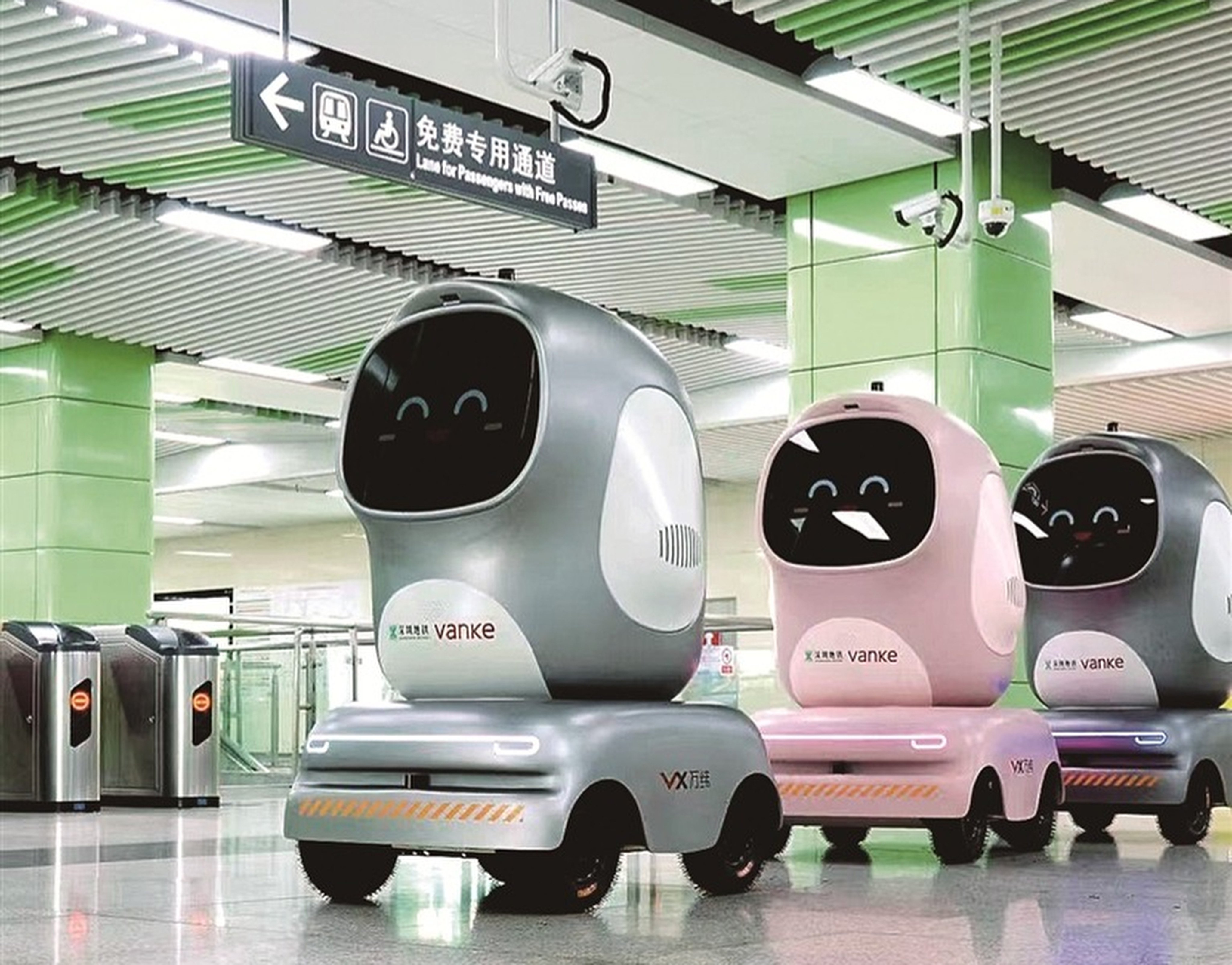 Three of the new delivery robots trundle across a subway station in Shenzhen, Guangdong province, on Tuesday. Photo: Handout