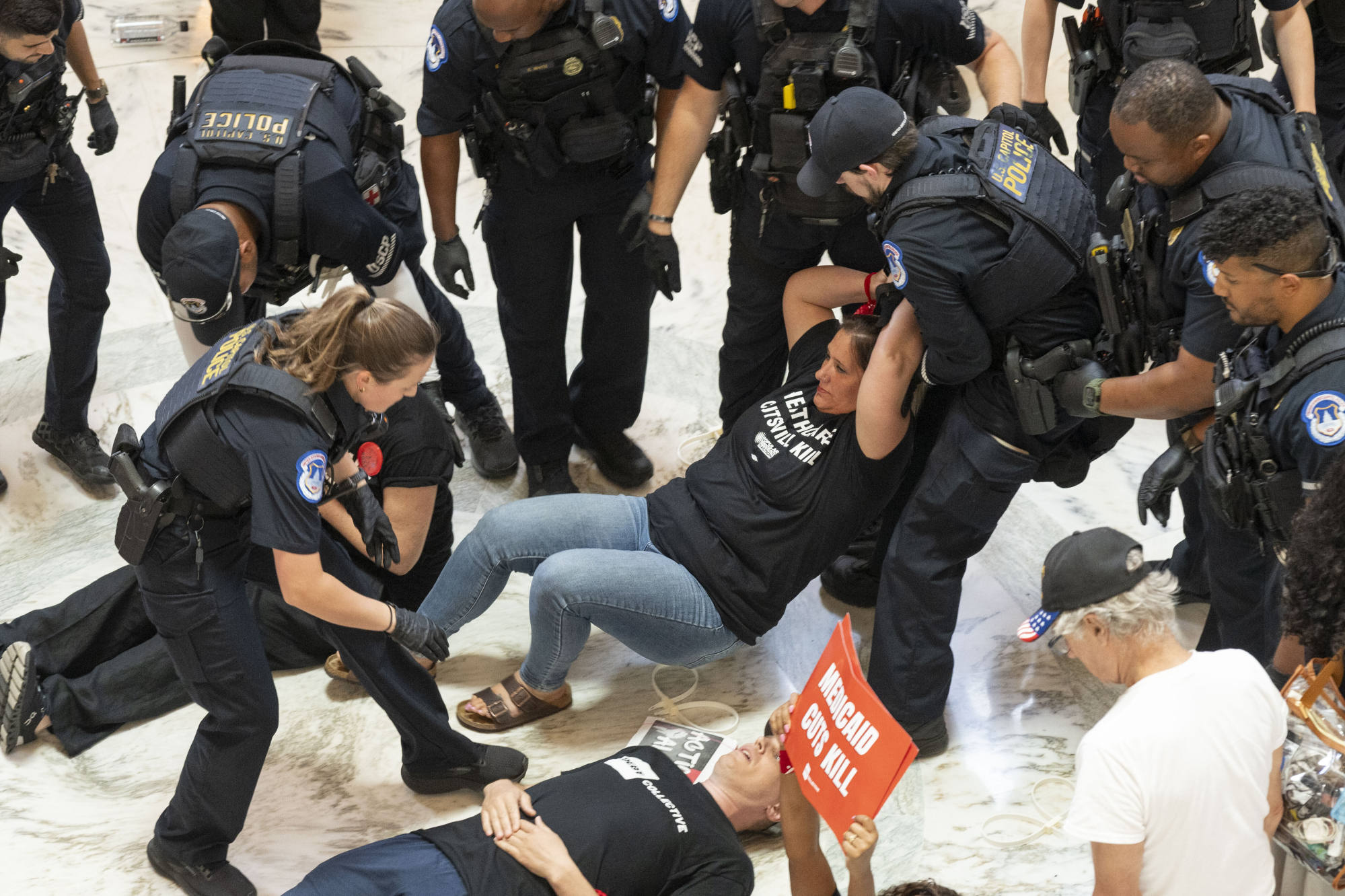 Medicaid and SNAP recipients are arrested during a protest on June 25 in Washington against proposed cuts to social safety net programmes. Photo: AP